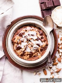 A beautifully arranged bowl of Almond Joy Oatmeal with rich chocolate, coconut, and almonds.