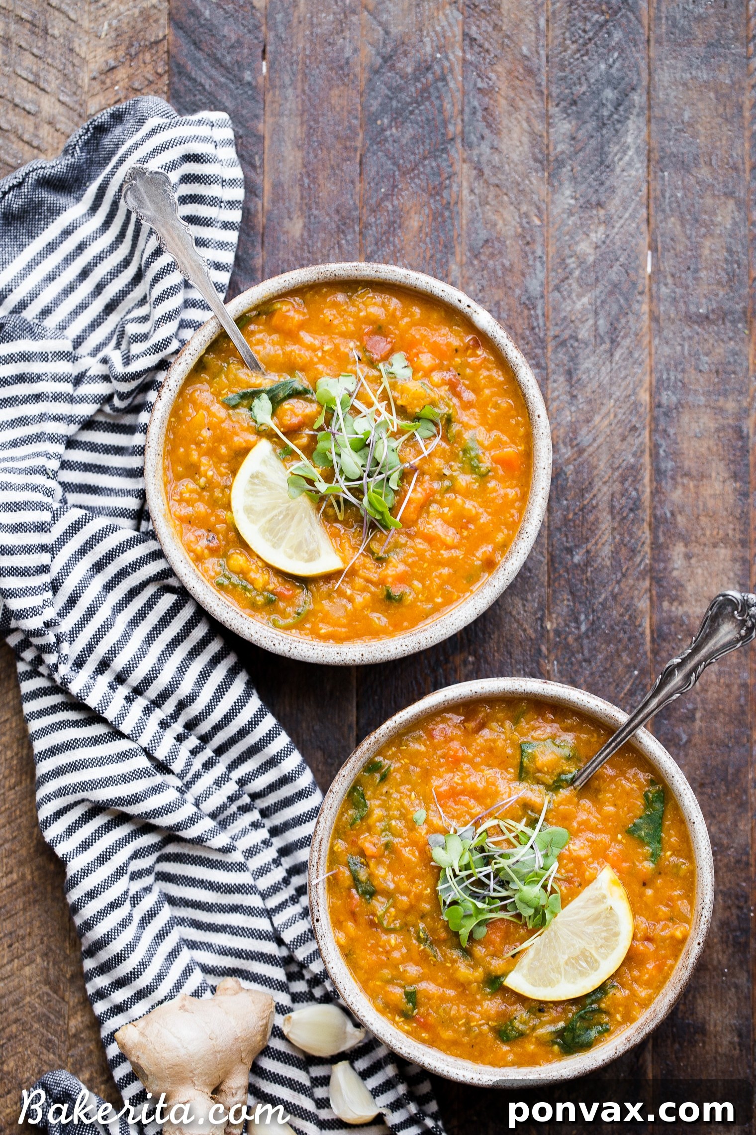 Creamy Vegan Red Lentil Delight 6 Two vibrant bowls of Vegan Red Lentil Soup, elegantly topped with fresh microgreens and a bright lemon wedge, creating a perfect healthy vegan dinner presentation.