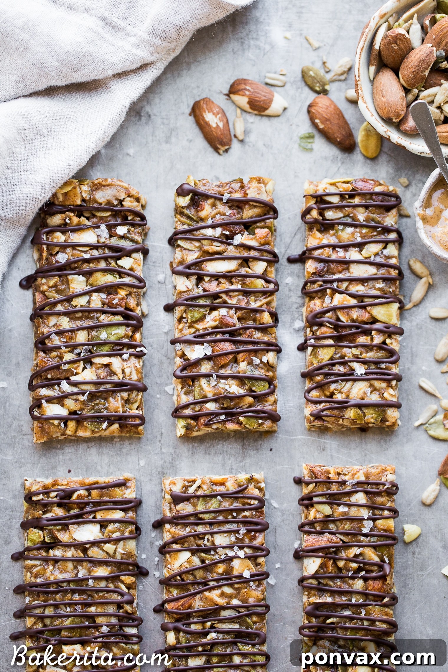 Activated Wholesome Nut Seed Bars 2 A beautifully arranged stack of dark chocolate drizzled No-Bake Sprouted Nut & Seed Granola Bars, ready to be enjoyed.