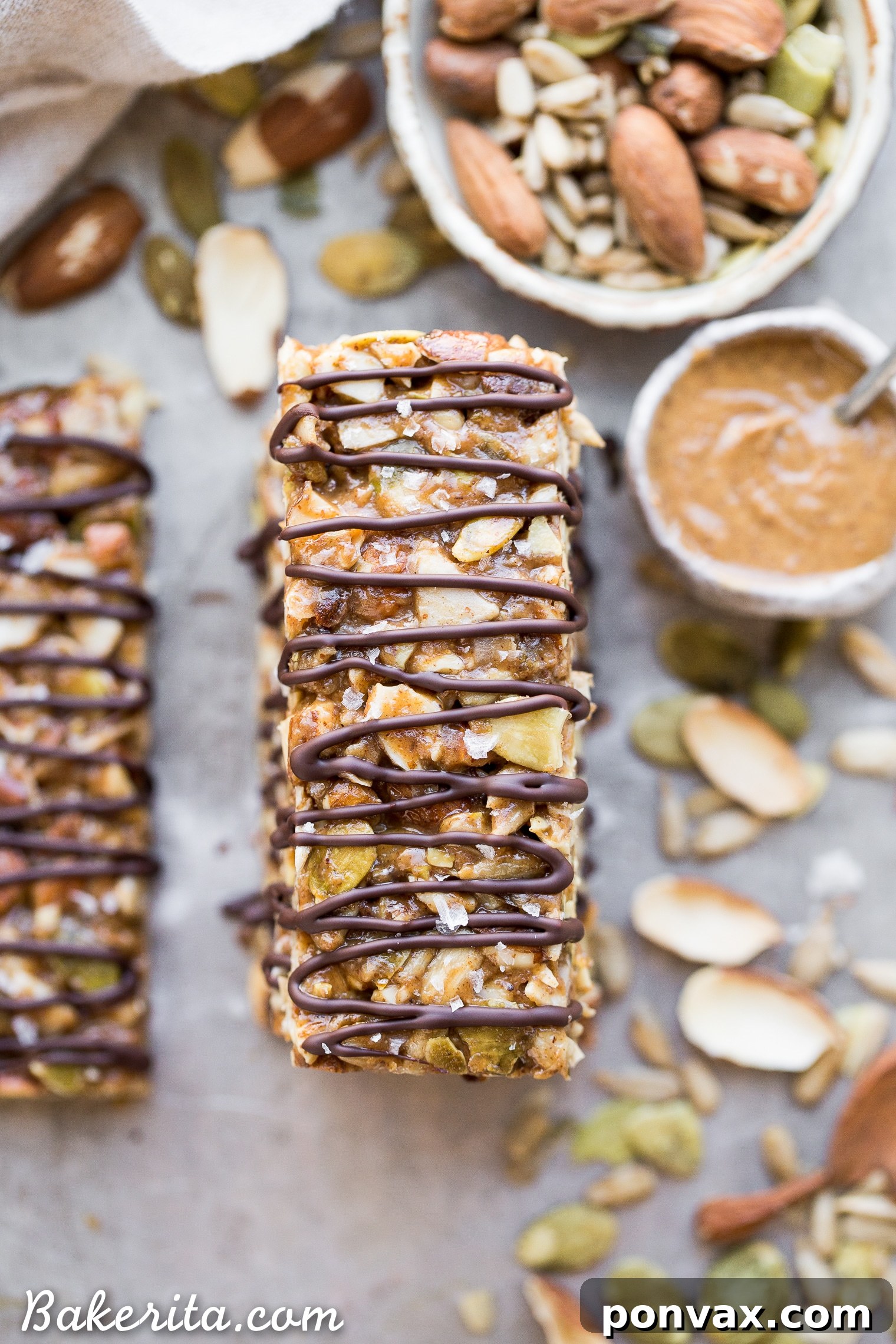 Activated Wholesome Nut Seed Bars 5 A batch of freshly made No-Bake Sprouted Nut & Seed Granola Bars, meticulously cut and arranged on parchment paper.