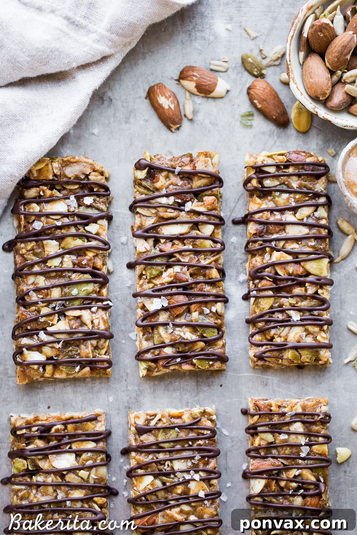 Activated Wholesome Nut Seed Bars 6 A hand gently breaking a segment off a homemade No-Bake Sprouted Nut & Seed Granola Bar, showcasing its firm yet yielding texture.