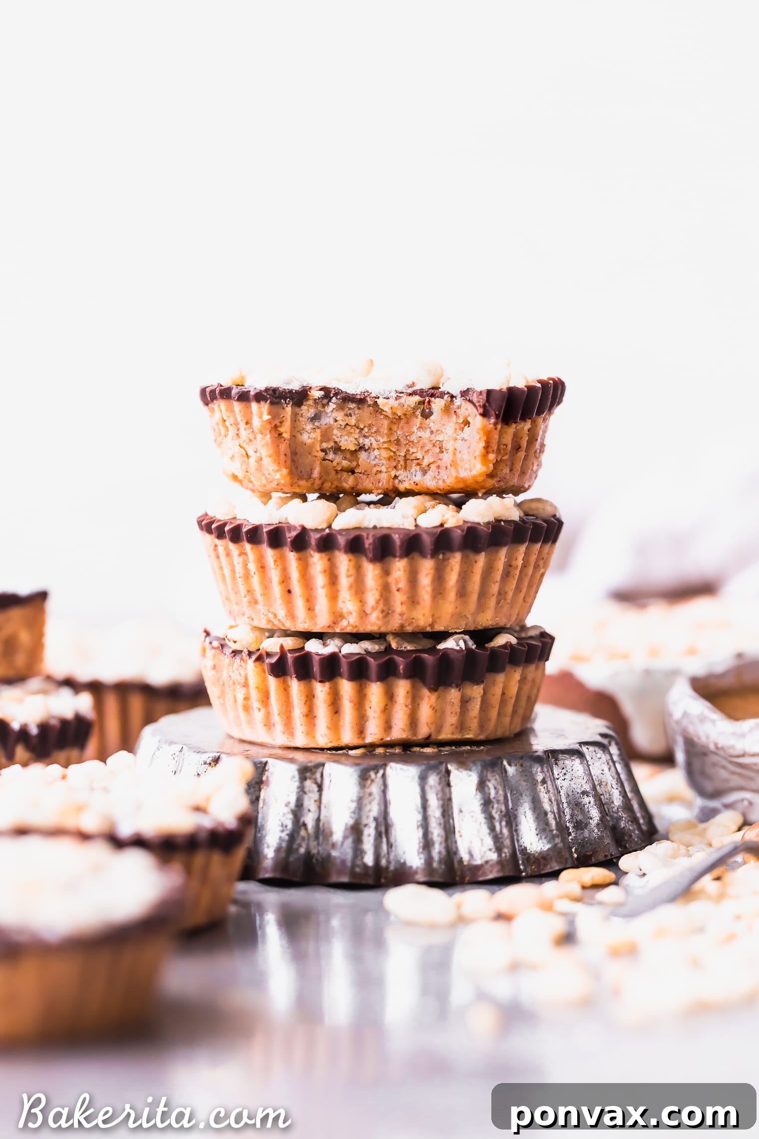 Decadent Crispy Chocolate Almond Butter Bites Vegan Gluten Free 4 A plate of No-Bake Crispy Chocolate Almond Butter Cups, garnished with extra cereal and sea salt.