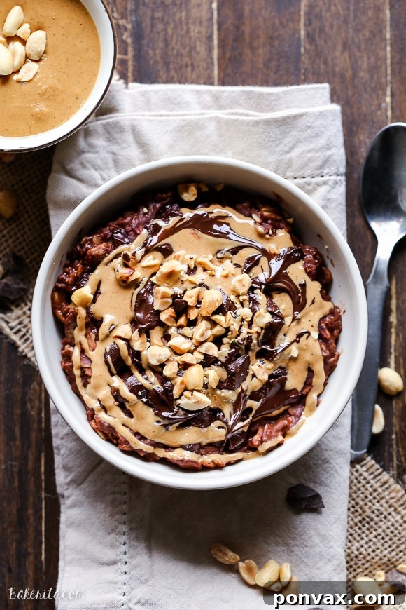 A beautifully presented bowl of creamy Chocolate Peanut Butter Oatmeal, adorned with chocolate chips and chopped peanuts, ready to be enjoyed.