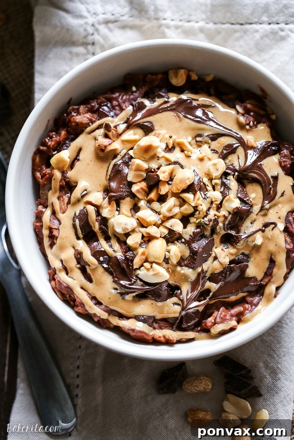 A person enjoying a spoonful of the freshly prepared Chocolate Peanut Butter Oatmeal, showing its inviting texture.