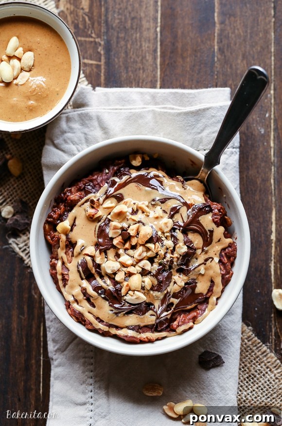 A vibrant bowl of Chocolate Peanut Butter Oatmeal, artfully topped with a variety of textures including nuts and chocolate.