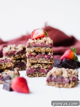 These Strawberry Chocolate Chunk Oatmeal Bars have an oatmeal cookie crust and crumble, filled with fresh strawberries and dark chocolate chunks - it makes for an irresistibly delicious treat! These oatmeal bars are gluten-free, refined sugar-free, and vegan.