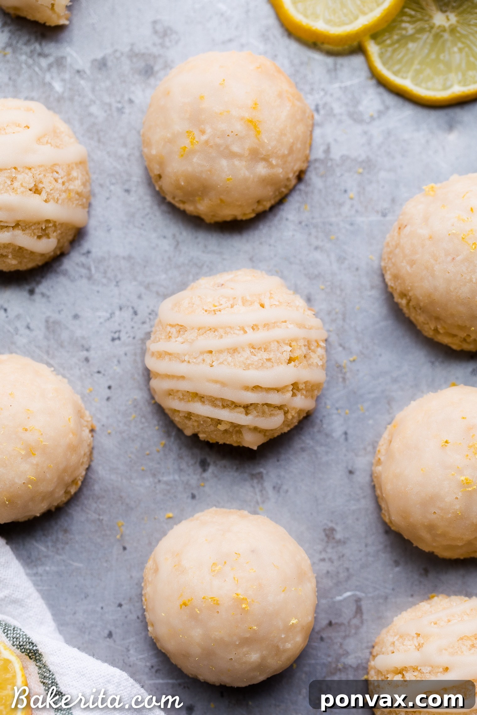 Finished Lemon Macaroons with a glistening tart lemon glaze, garnished with lemon zest. A delectable gluten-free, paleo, and vegan treat.