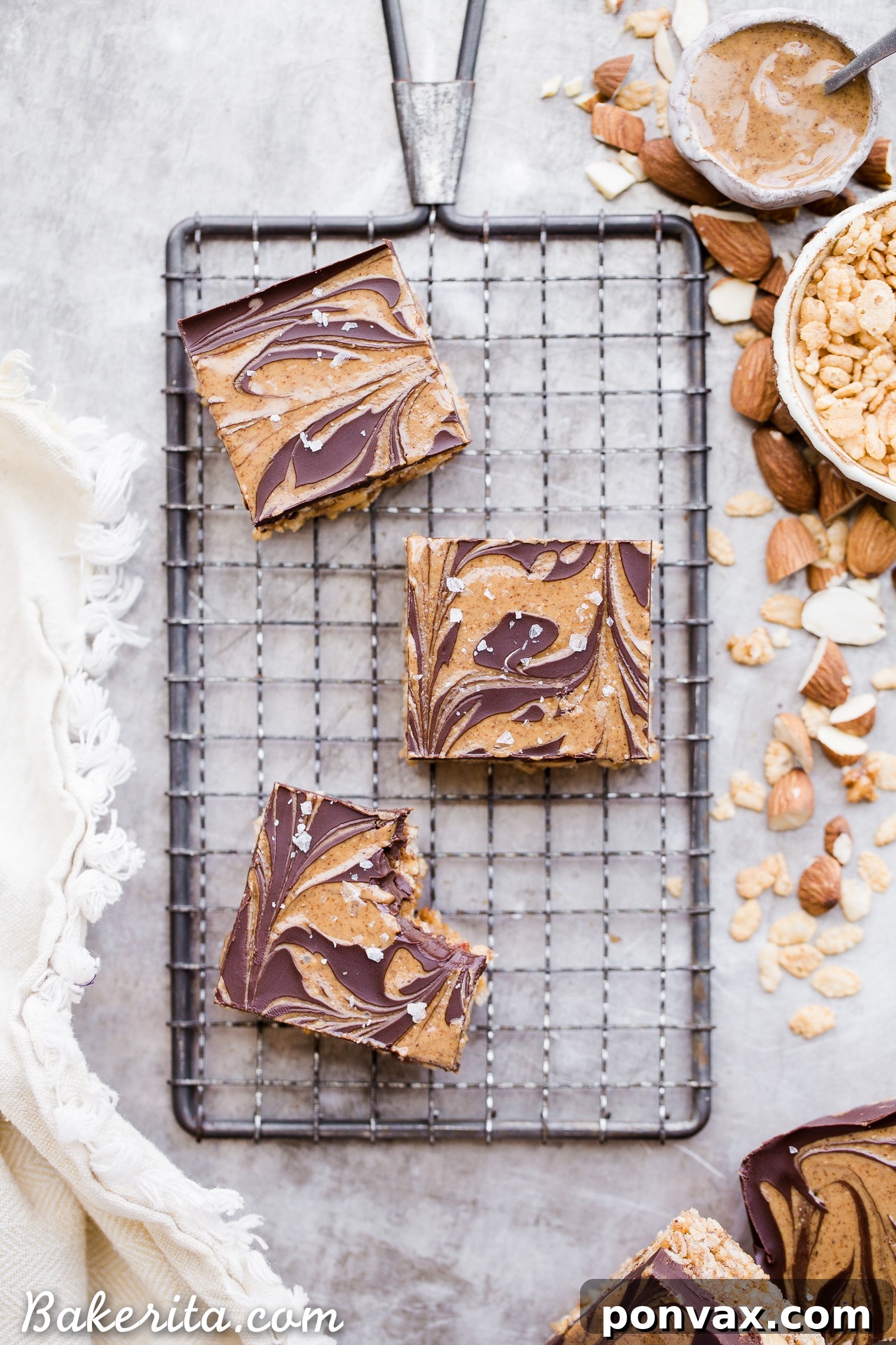 Guilt Free Crispy Chocolate Almond Butter Bars 6 The chocolate and almond butter topping being swirled onto the crispy bar base in a pan.
