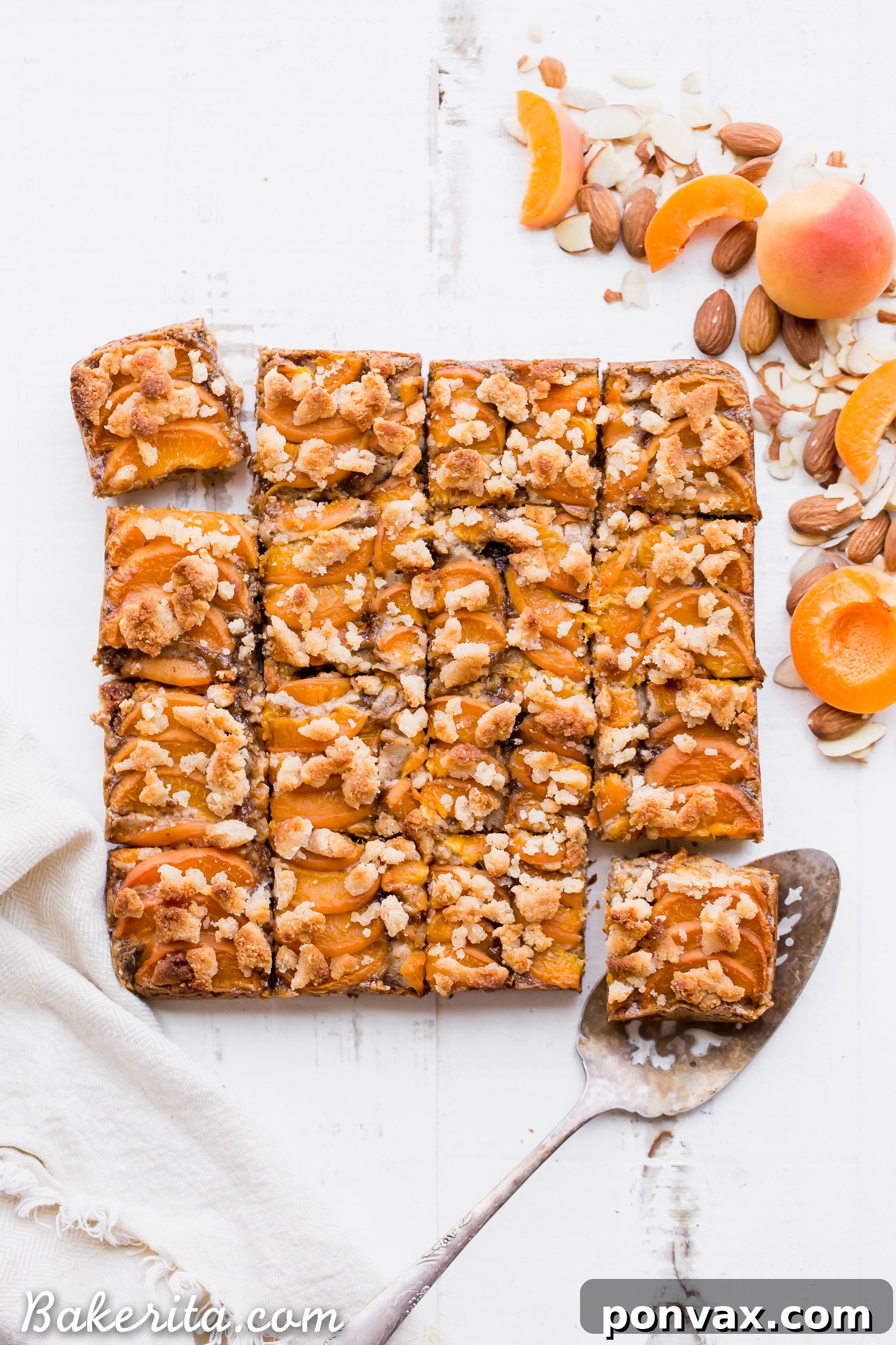 Close-up of golden Apricot Frangipane Bars with fresh apricots and crumb topping.