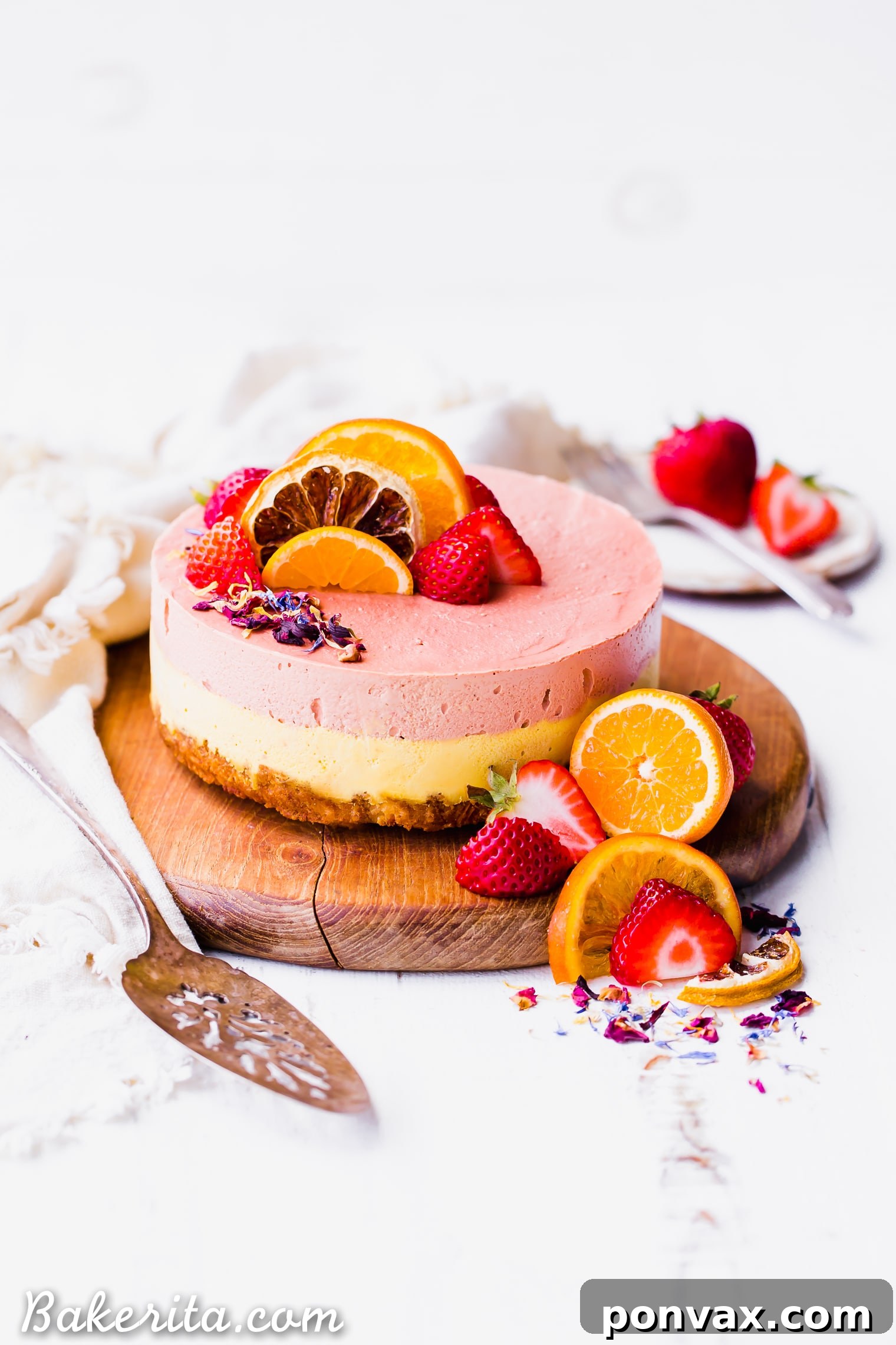 This Strawberry Orange Cheesecake with Coconut Crust is not just beautiful, but it's bright in flavor and absolutely delicious! The lemony coconut macaroon crust is perfect with the strawberry and orange flavors. You're going to adore this gluten-free, paleo and vegan cheesecake. 