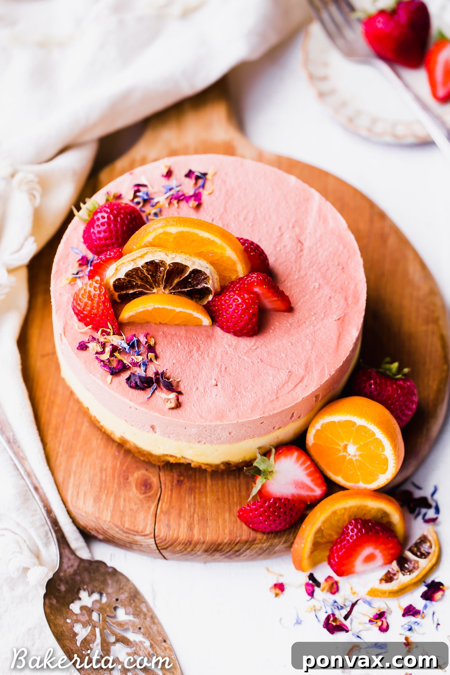 This Strawberry Orange Cheesecake with Coconut Crust is not just beautiful, but it's bright in flavor and absolutely delicious! The lemony coconut macaroon crust is perfect with the strawberry and orange flavors. You're going to adore this gluten-free, paleo and vegan cheesecake. 