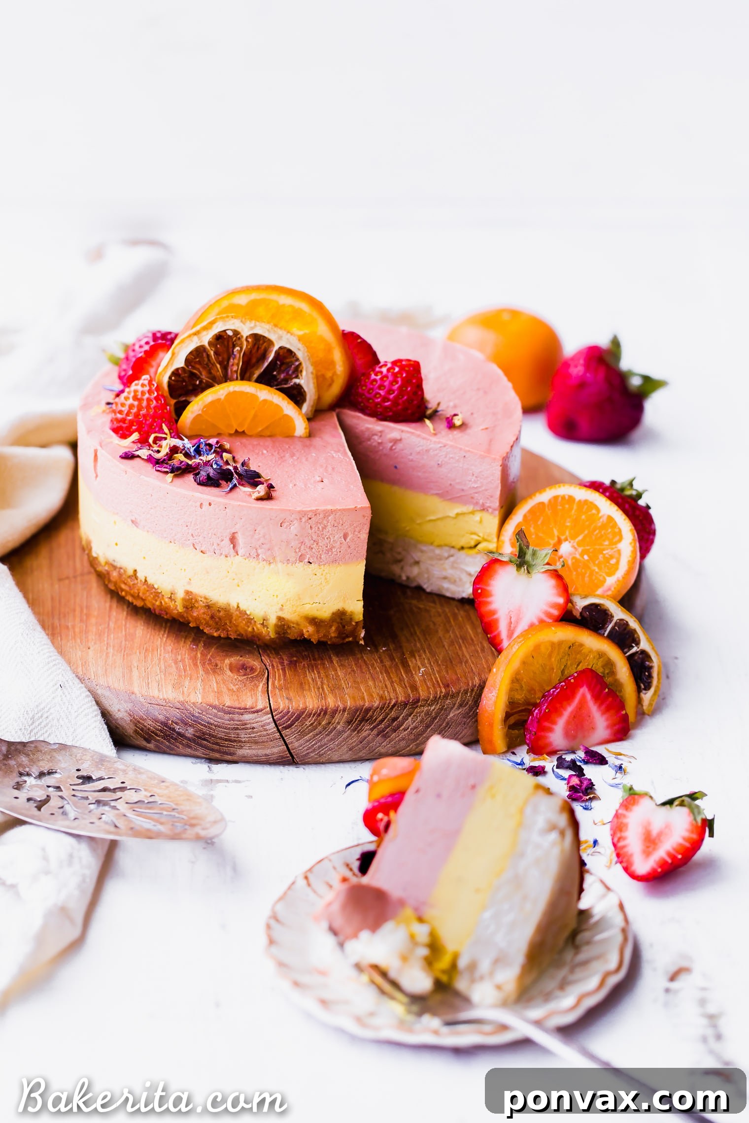 This Strawberry Orange Cheesecake with Coconut Crust is not just beautiful, but it's bright in flavor and absolutely delicious! The lemony coconut macaroon crust is perfect with the strawberry and orange flavors. You're going to adore this gluten-free, paleo and vegan cheesecake. 