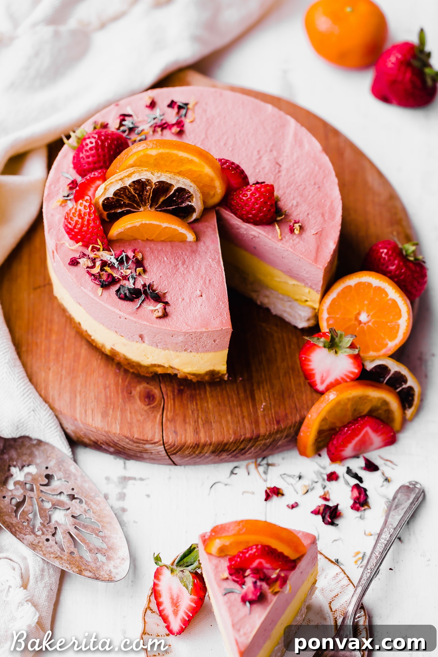 This Strawberry Orange Cheesecake with Coconut Crust is not just beautiful, but it's bright in flavor and absolutely delicious! The lemony coconut macaroon crust is perfect with the strawberry and orange flavors. You're going to adore this gluten-free, paleo and vegan cheesecake. 