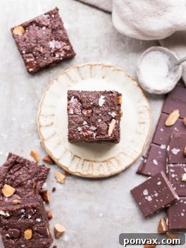 Fudgy, gluten-free, paleo, and vegan Salted Almond Brownies with a rich chocolate flavor, toasted almonds, and sea salt.