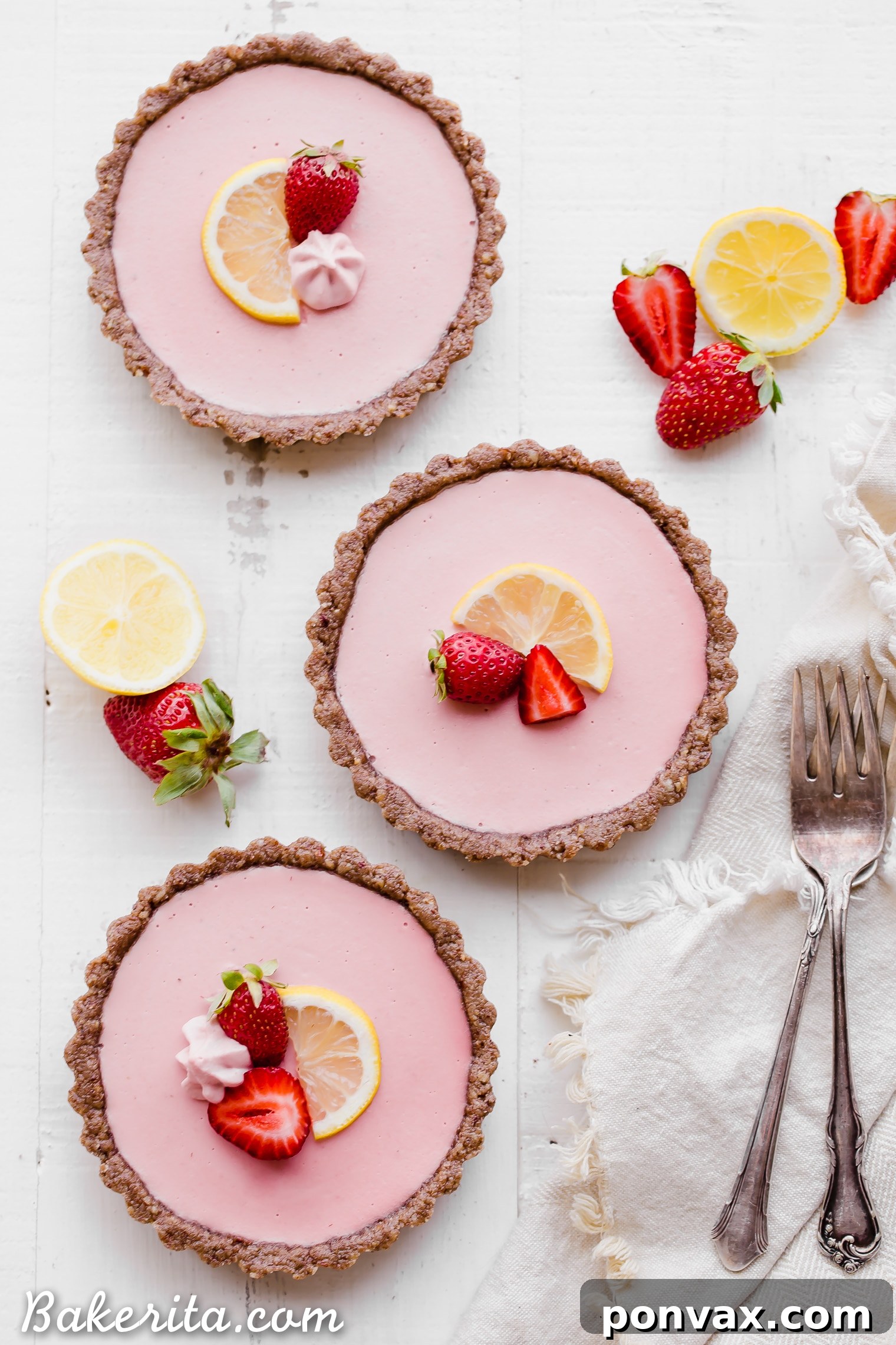 Close-up of No Bake Strawberry Lemonade Tarts, showcasing the creamy pink filling and the golden crust. A perfect healthy summer dessert.