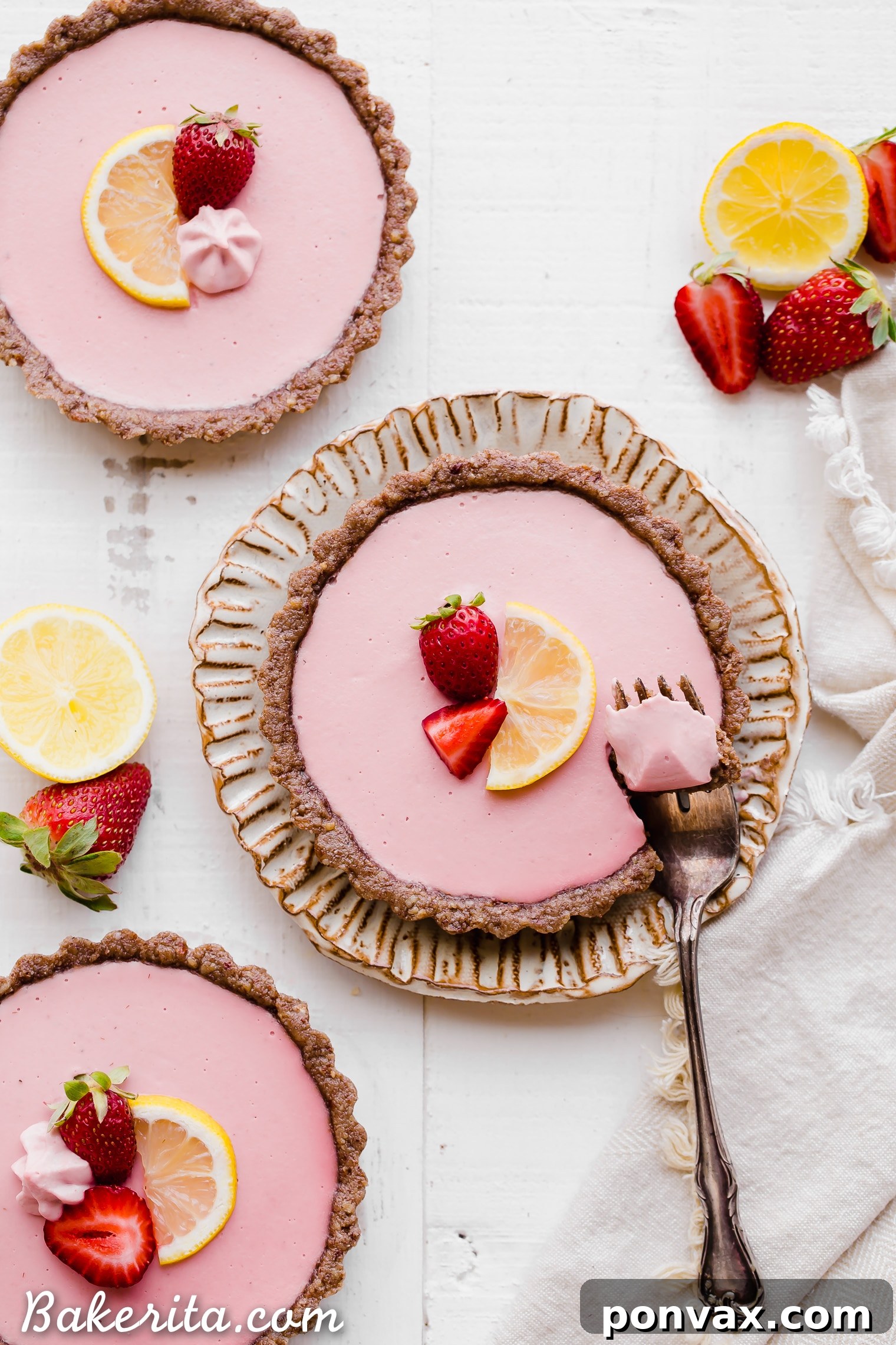 A plate of No Bake Strawberry Lemonade Tarts, highlighting the fresh strawberries used in the recipe. Ideal for gluten-free, paleo, and vegan diets.