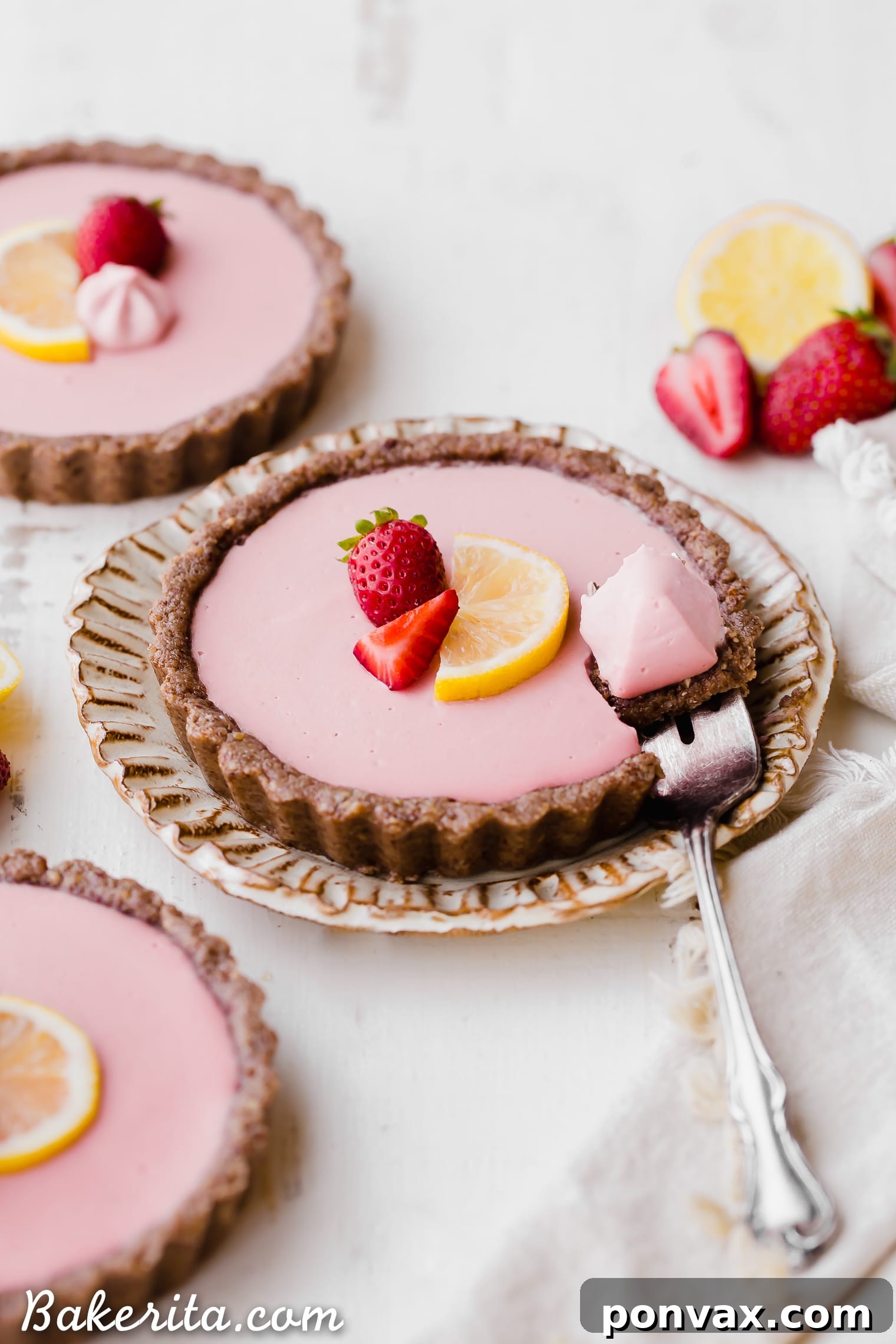 Several No Bake Strawberry Lemonade Tarts arranged on a serving platter, showing their delightful presentation. Perfect for those following a paleo diet.