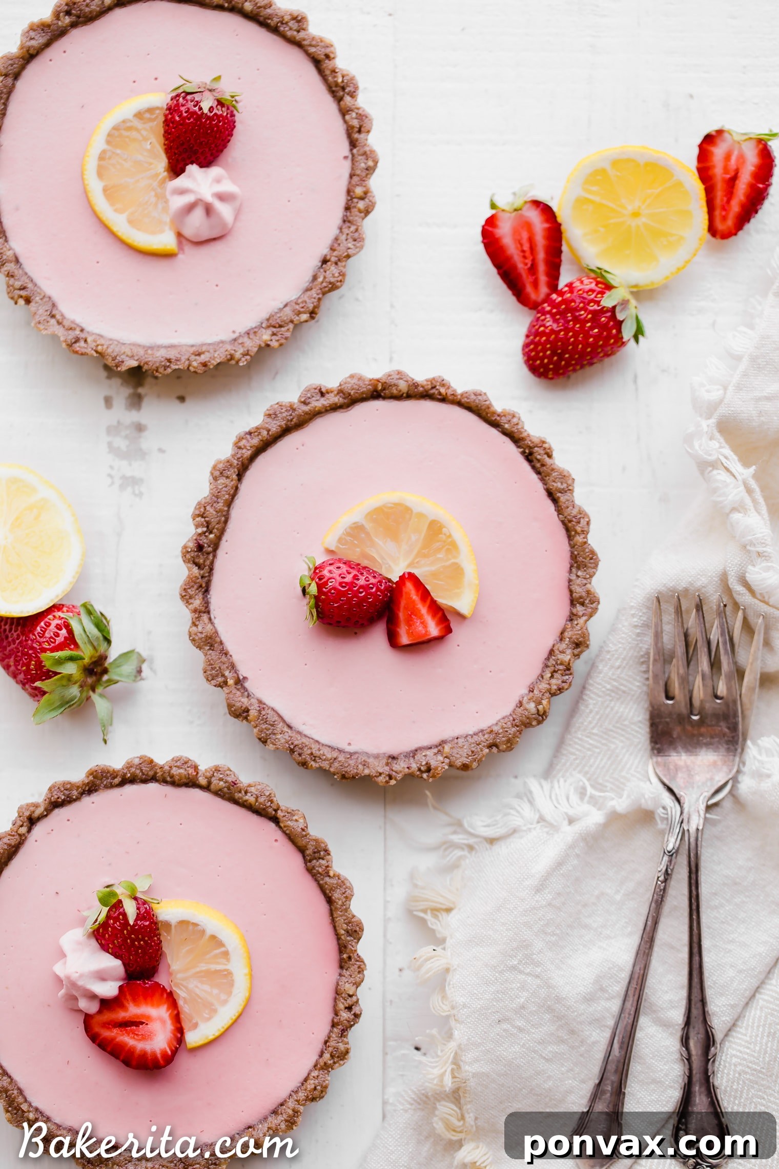 No Bake Strawberry Lemonade Tarts with a vibrant strawberry slice garnish. A healthy, dairy-free, and gluten-free dessert option.