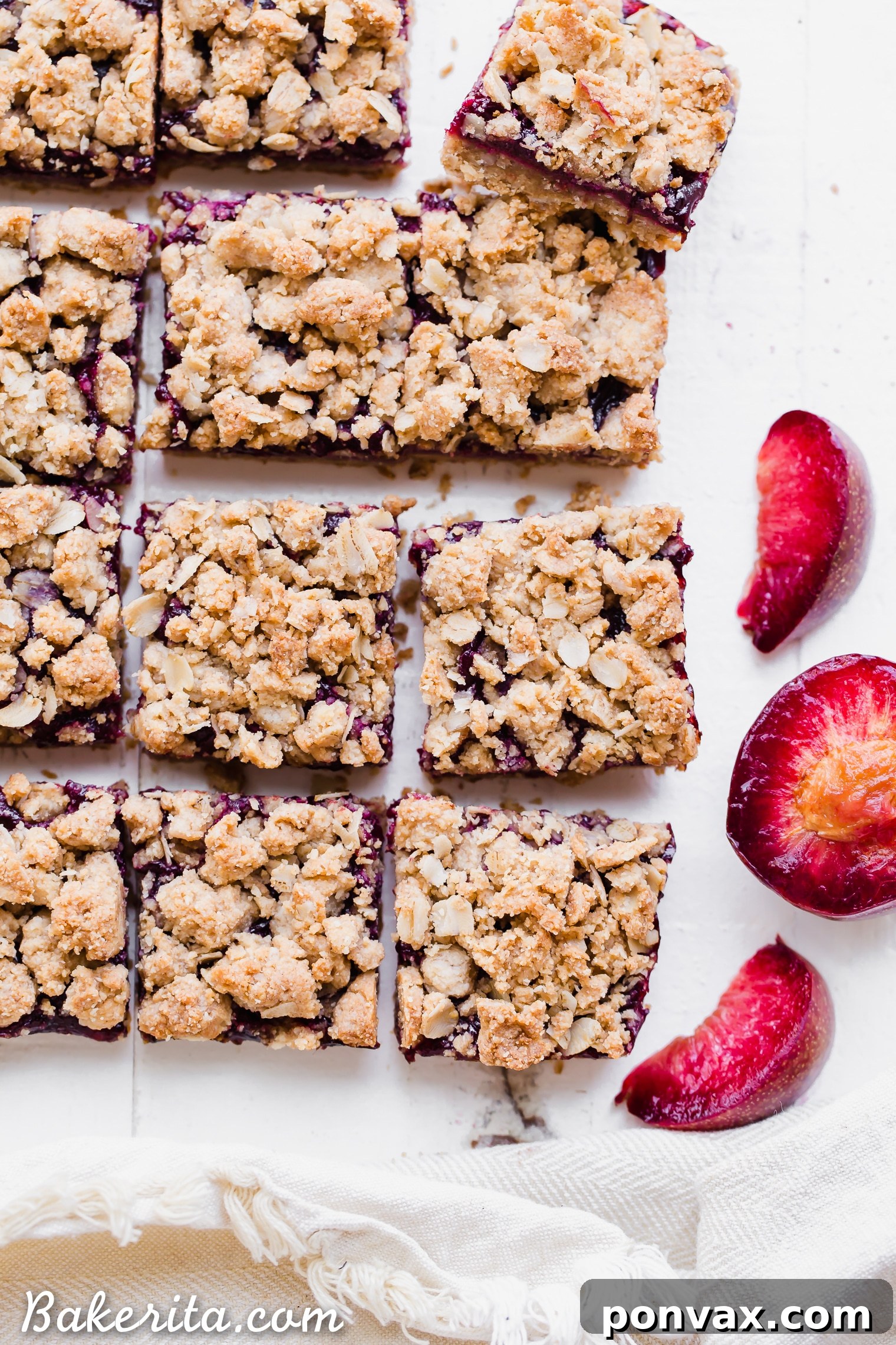A close-up of delicious Plum Crumble Bars showcasing their golden oatmeal crumble and vibrant plum jam filling. These gluten-free and vegan treats are perfect for showcasing summer plums.