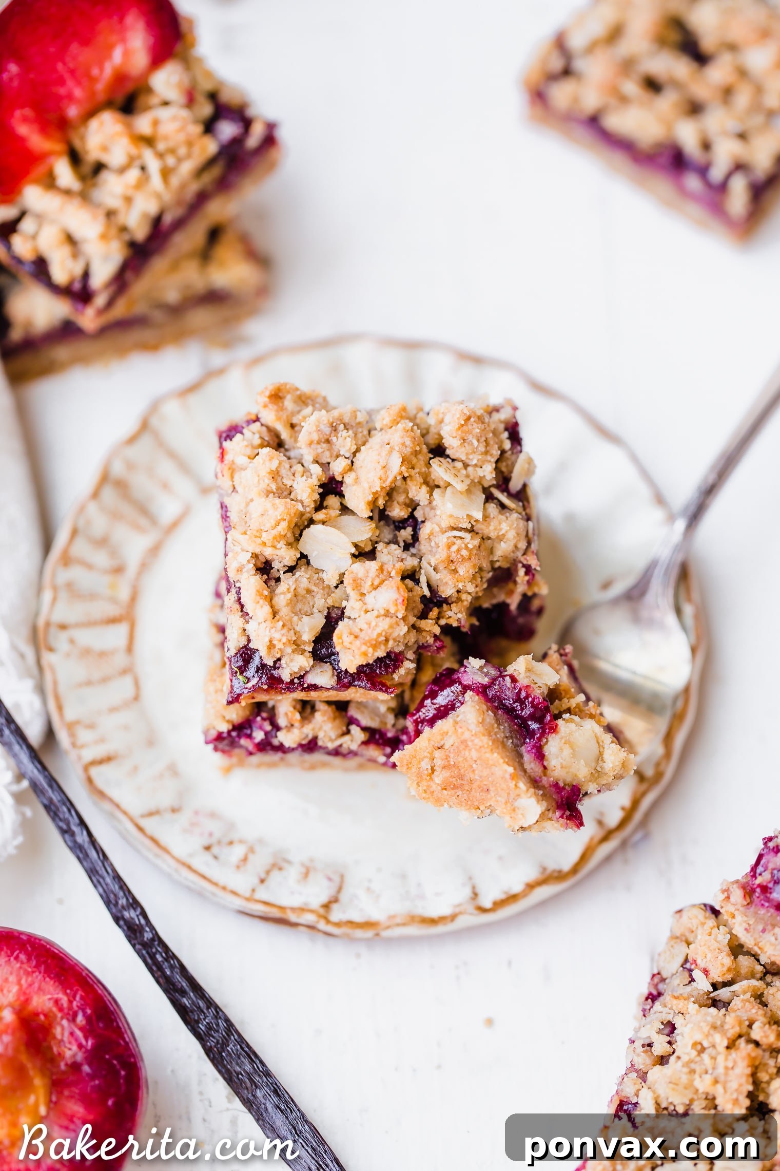 A stack of perfectly cut Plum Crumble Bars, showcasing layers of golden crumble, spiced plum jam, and a wholesome oatmeal crust. These gluten-free and vegan bars are ready to be enjoyed.