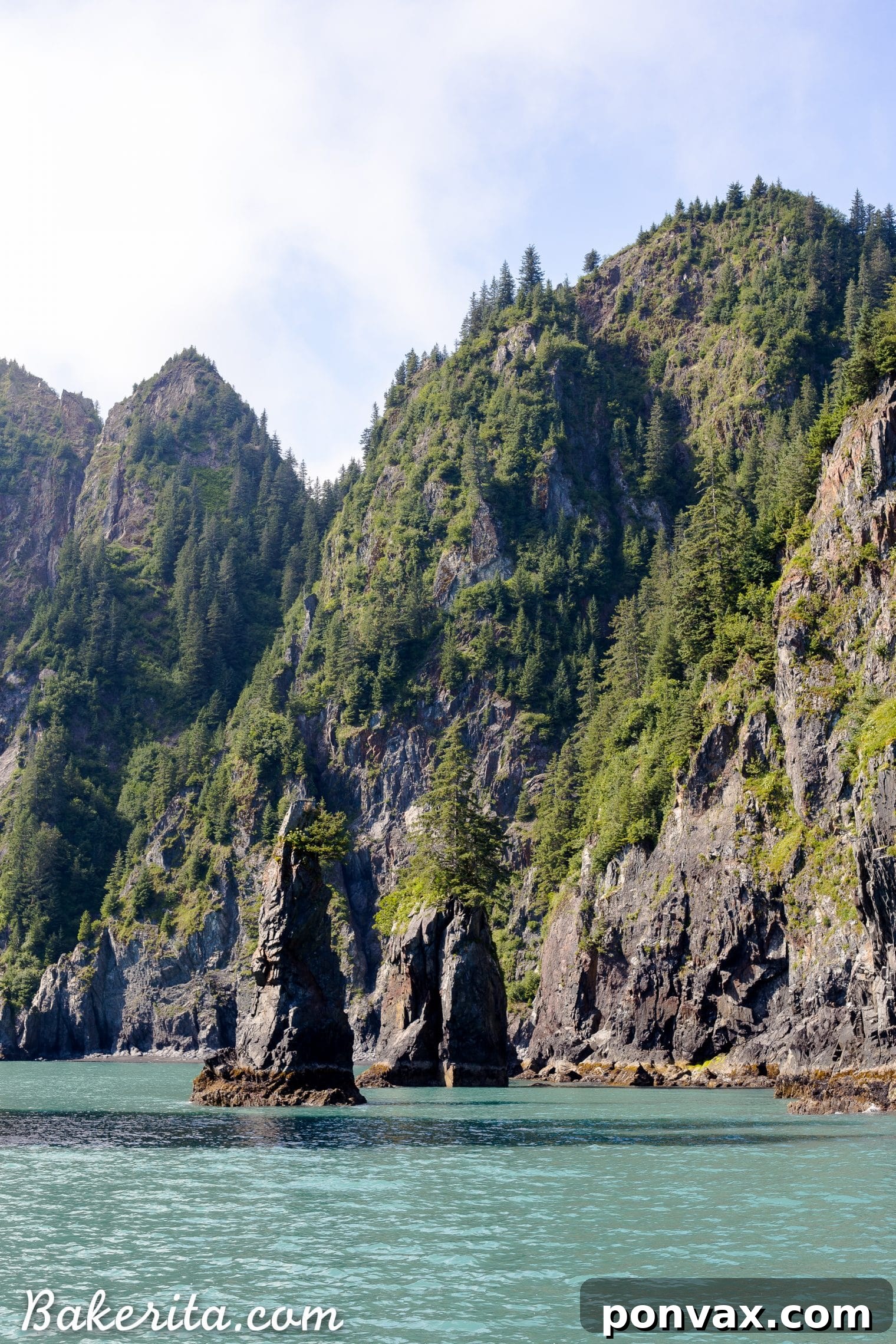 A calm bay surrounded by lush green mountains and a small boat
