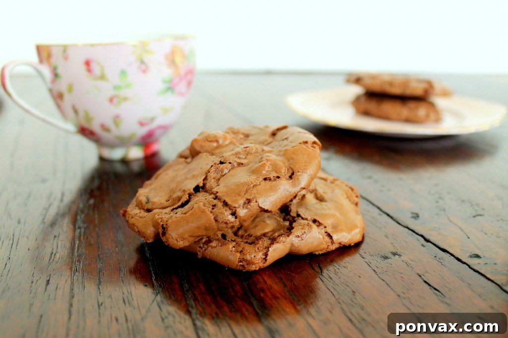 Close-up of baked chocolate cherry walnut cookies, showing their crinkled tops and a hint of the delicious fillings.