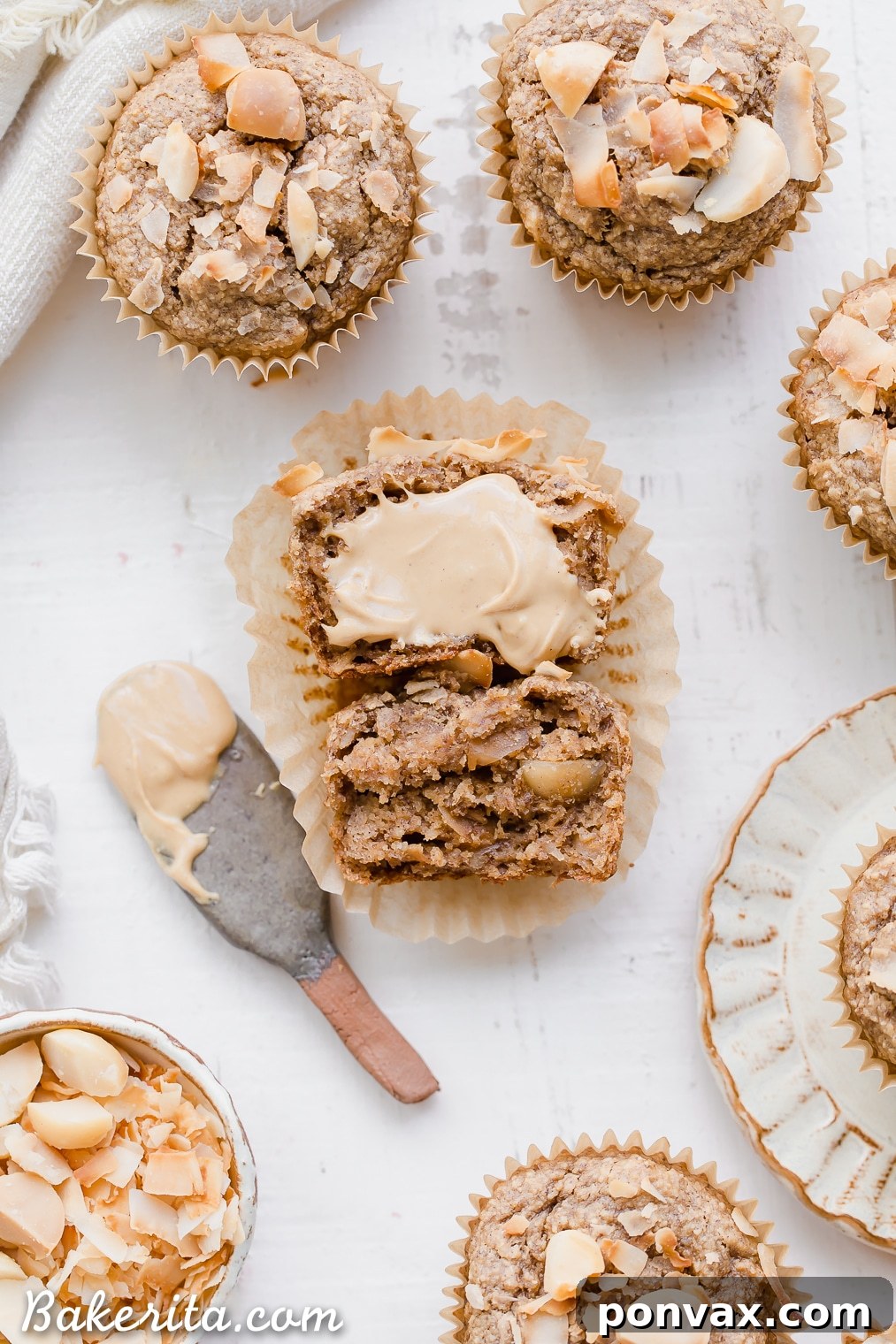 Wholesome Macadamia Nut Coconut Banana Muffins Vegan Gluten Free 5 A Macadamia Nut Coconut Banana Muffin on a cooling rack, freshly baked and radiating warmth. The golden crust and visible tropical inclusions make it look particularly appealing for a cozy morning treat.