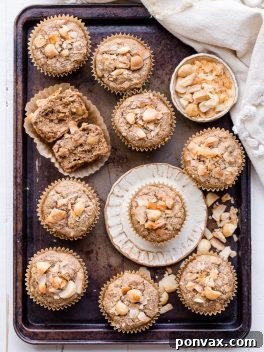 Wholesome Macadamia Nut Coconut Banana Muffins Vegan Gluten Free 8 A delicious Macadamia Nut Coconut Banana Muffin, showcasing its appealing texture and golden-brown crust. This image captures the essence of a wholesome, homemade vegan and gluten-free treat.