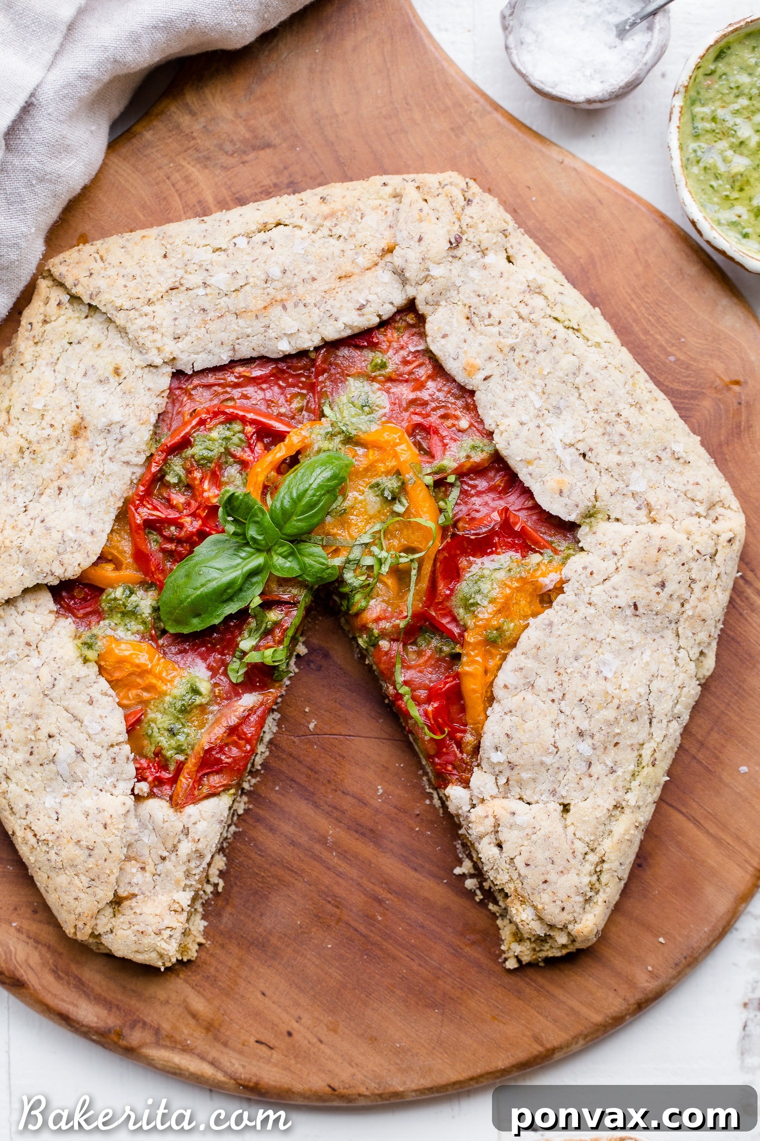 Rustic Gluten-Free Pesto Tomato Galette 4 This Pesto + Heirloom Tomato Galette has an incredibly flaky, savory crust filled with homemade pesto and thick slices of heirloom tomatoes. Served warm, it's a truly delicious appetizer or meal that you'd never guess is gluten-free, paleo, and vegan.