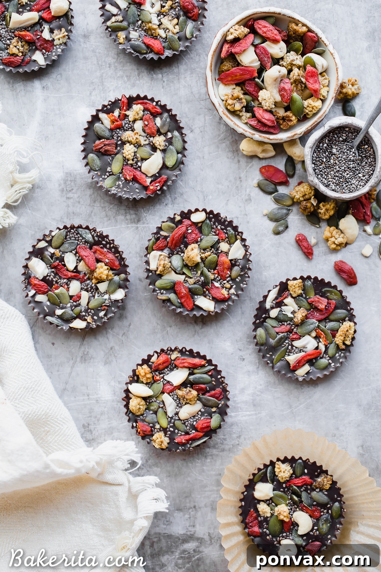 A hand gently picking up one of the Superfood Cacao Fudge Bites, showing its perfect square shape and the colorful superfood toppings. A tempting, healthy snack.