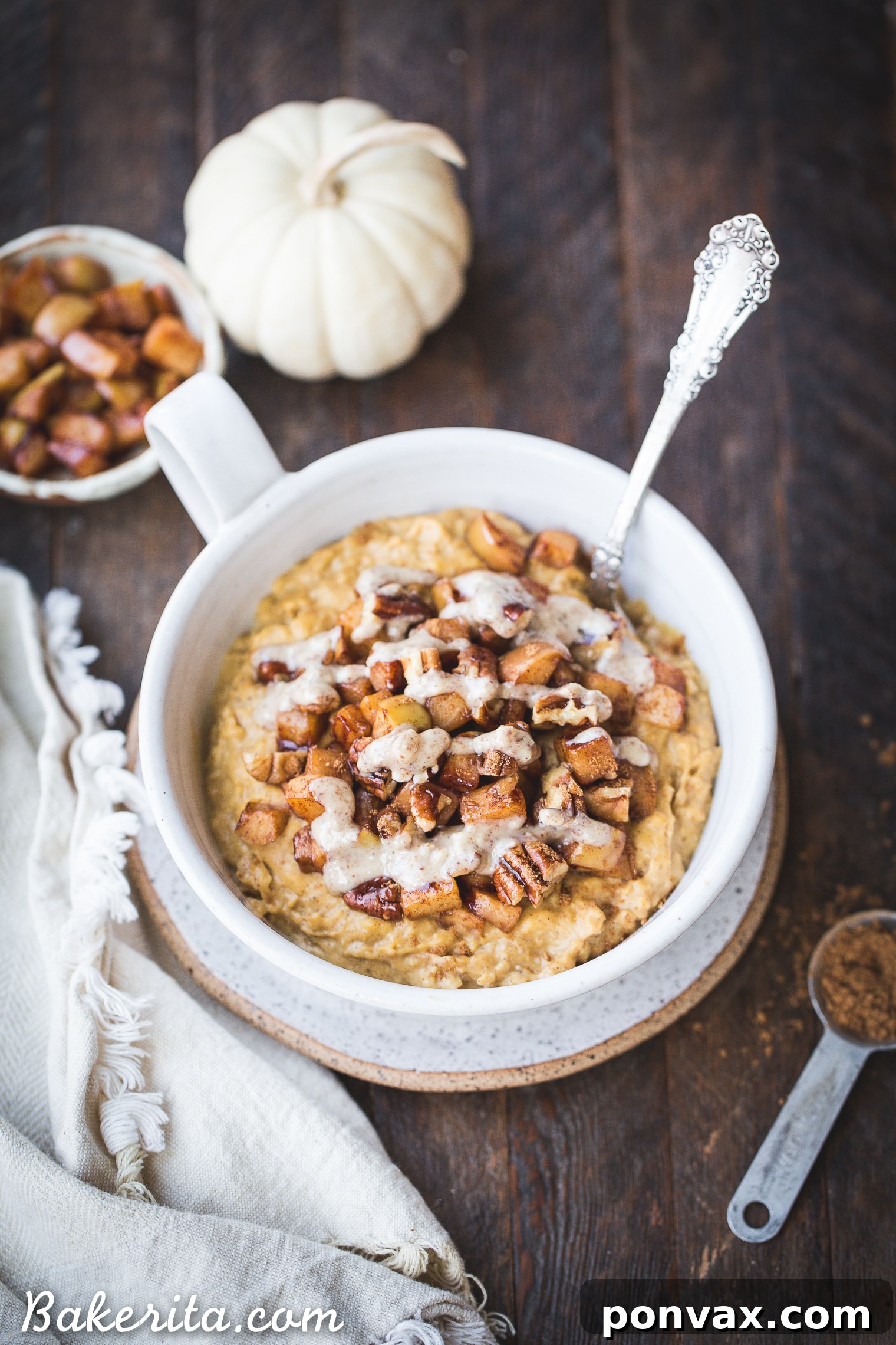 Warm Spiced Pumpkin Oats and Golden Caramel Apples 3 A close-up shot of creamy Pumpkin Spice Oatmeal topped with golden sauteed apples, perfect for a cozy autumn breakfast. This gluten-free and vegan recipe is sweetened with maple syrup.