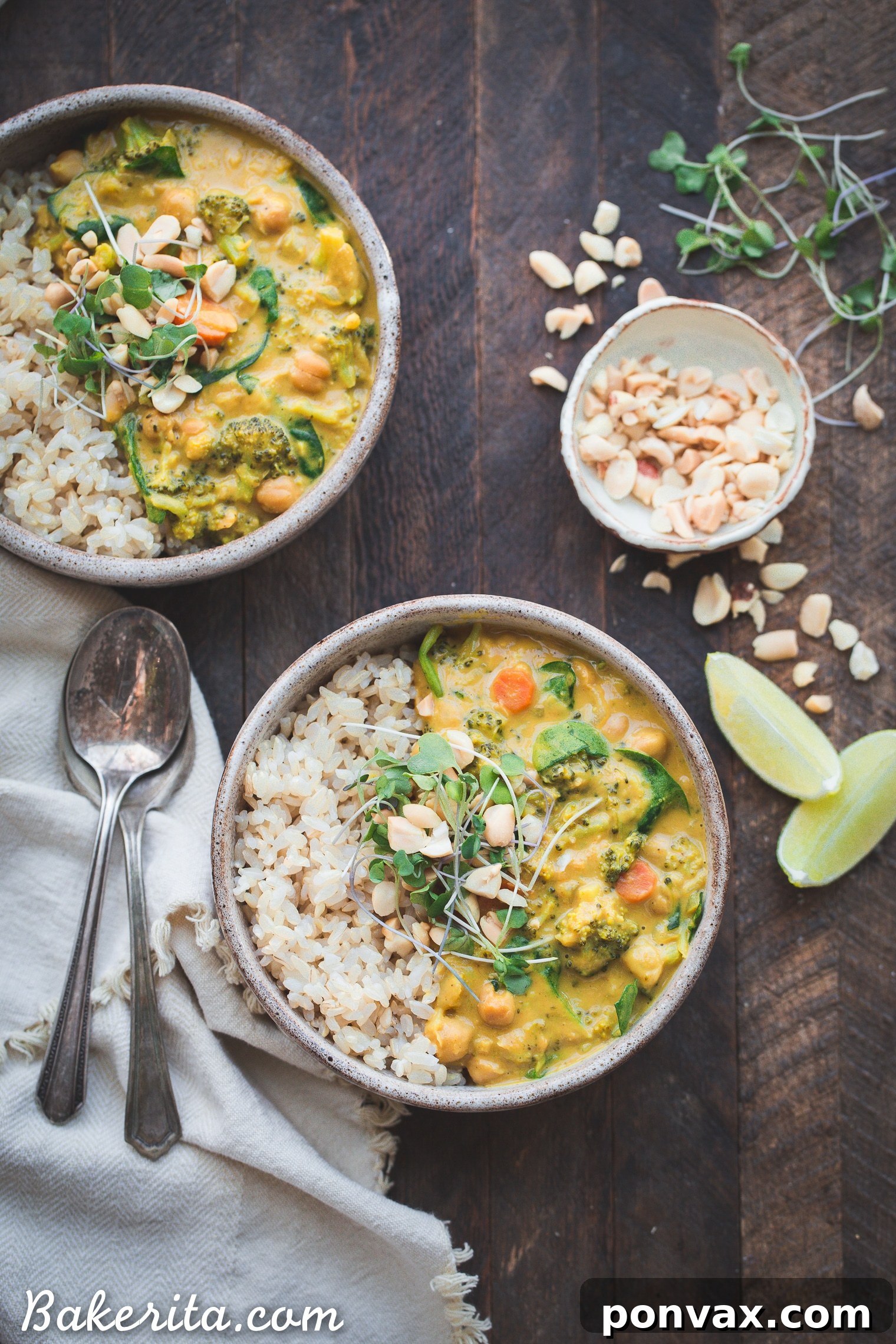 A vibrant bowl of Vegan Broccoli Chickpea Curry, garnished with fresh cilantro and a lime wedge, served alongside fluffy rice. The curry is rich, creamy, and loaded with tender broccoli florets and hearty chickpeas, promising a satisfying and healthy meal.
