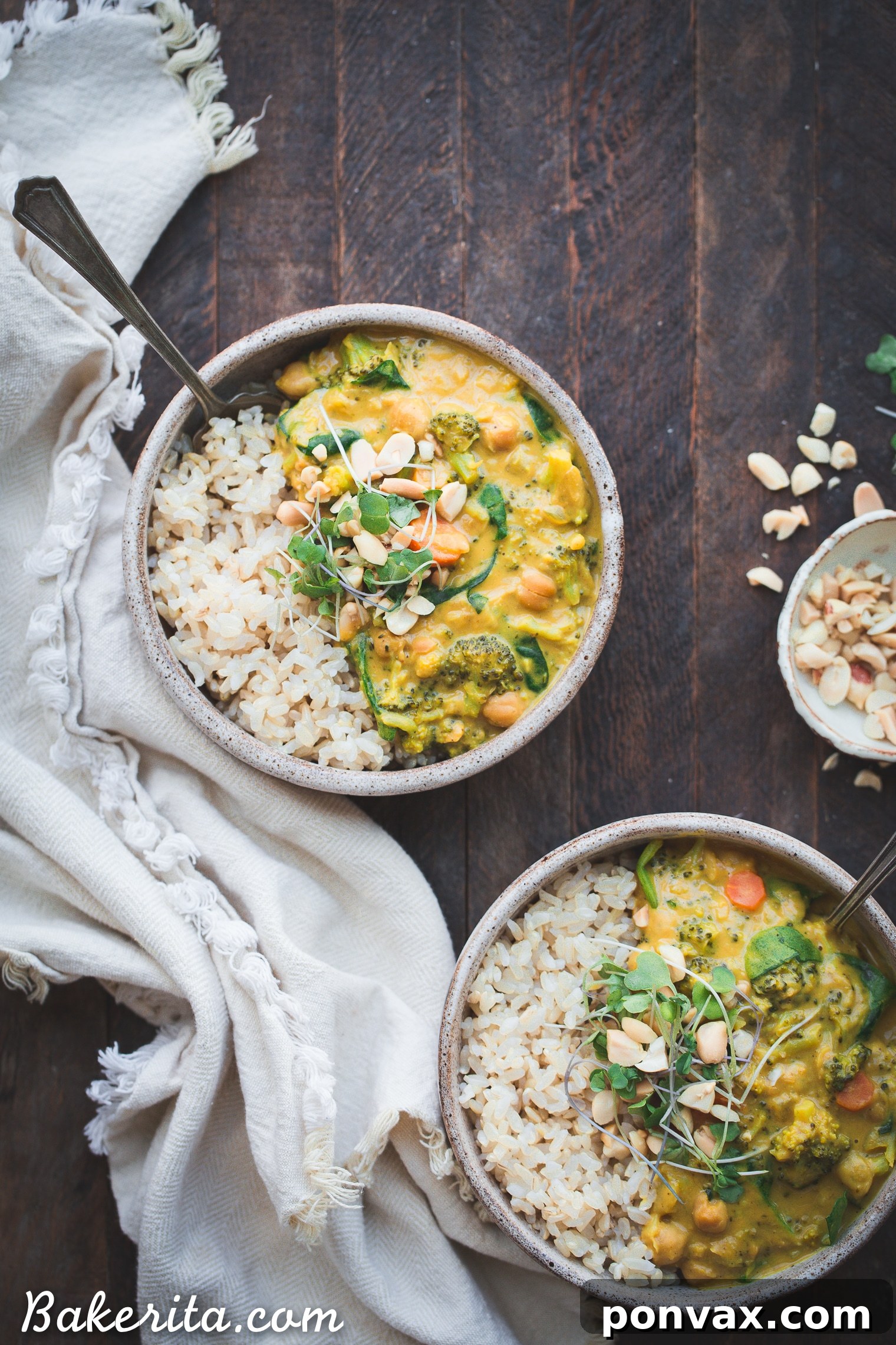 A generous serving of Vegan Broccoli Chickpea Curry presented in a bowl, with a spoon digging into the creamy texture, garnished with fresh lime and cilantro, showcasing its inviting appeal and readiness to be savored.