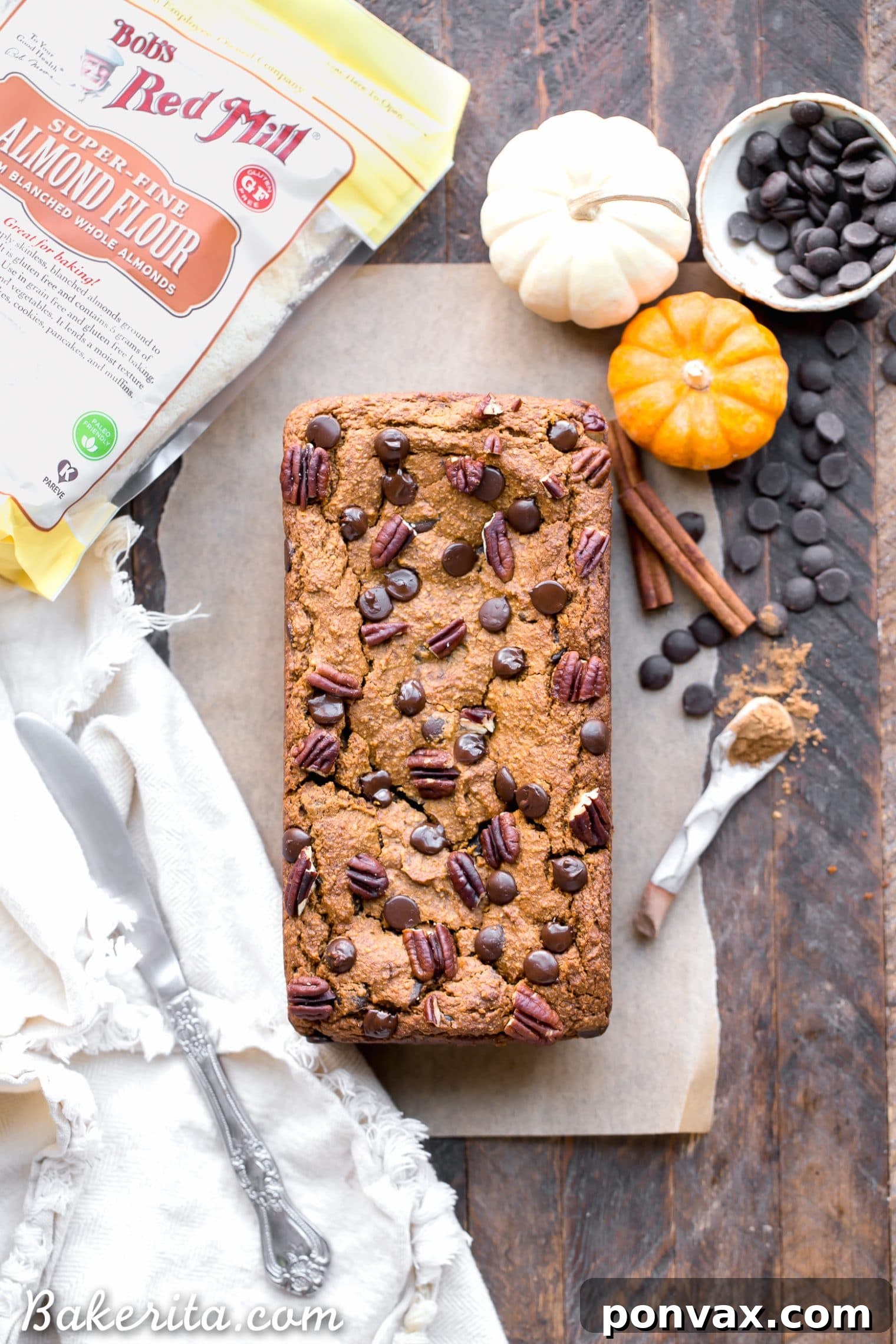 A beautiful loaf of Chocolate Chip Vegan Pumpkin Bread cooling on a wire rack, ready to be sliced, a perfect gluten-free and refined sugar-free autumnal delight.