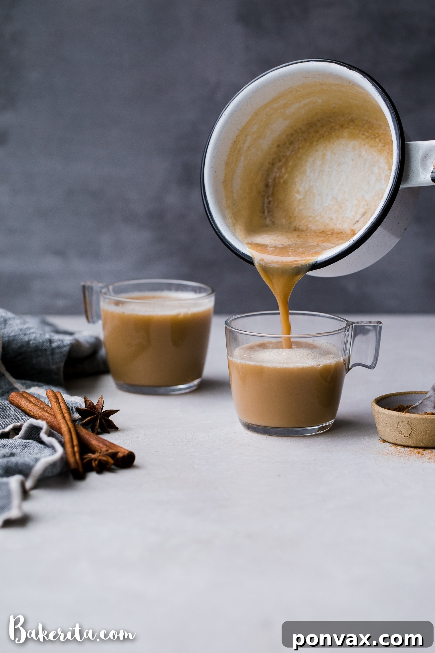 An overhead shot of a collection of vibrant whole and ground chai spices, including cinnamon sticks, star anise, ginger, and cardamom pods, ready to be blended for a homemade chai mix.
