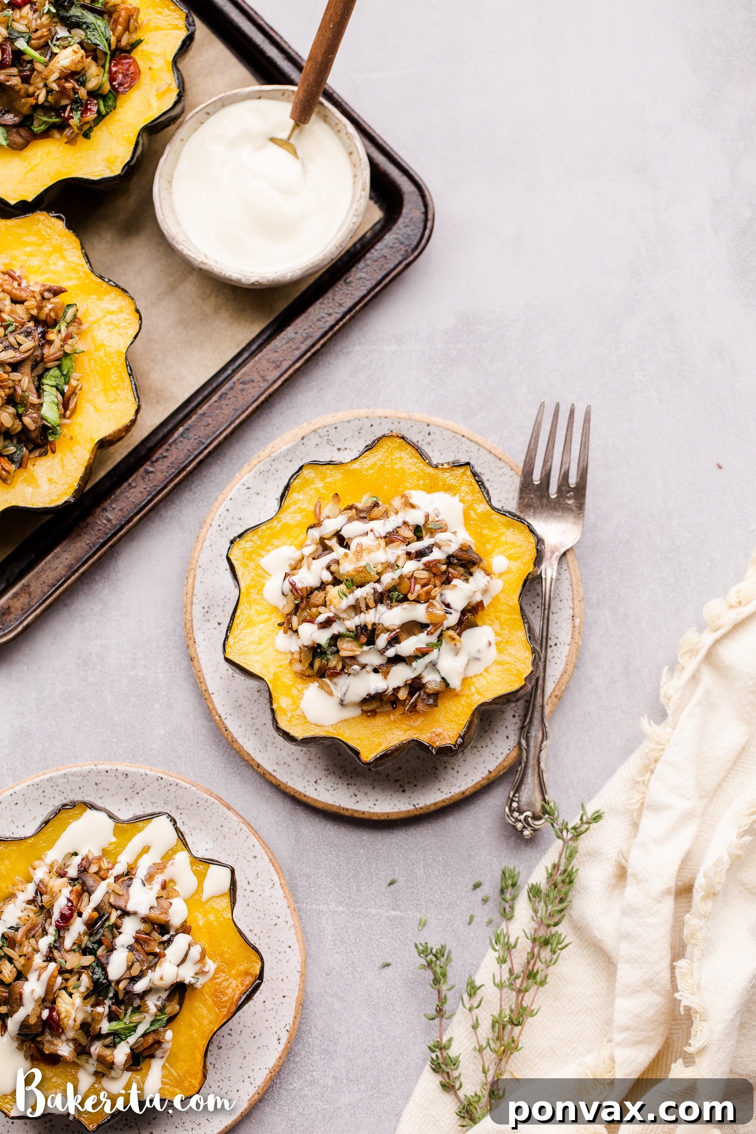 This Mushroom & Wild Rice Stuffed Acorn Squash is filled with caramelized onions, cauliflower florets, spinach, dried cranberries, and pecans. It's served with a drizzle of lemon tahini sauce. This comforting and colorful dish has a variety of texture, tons of flavor, and makes the perfect hearty dinner or side dish.