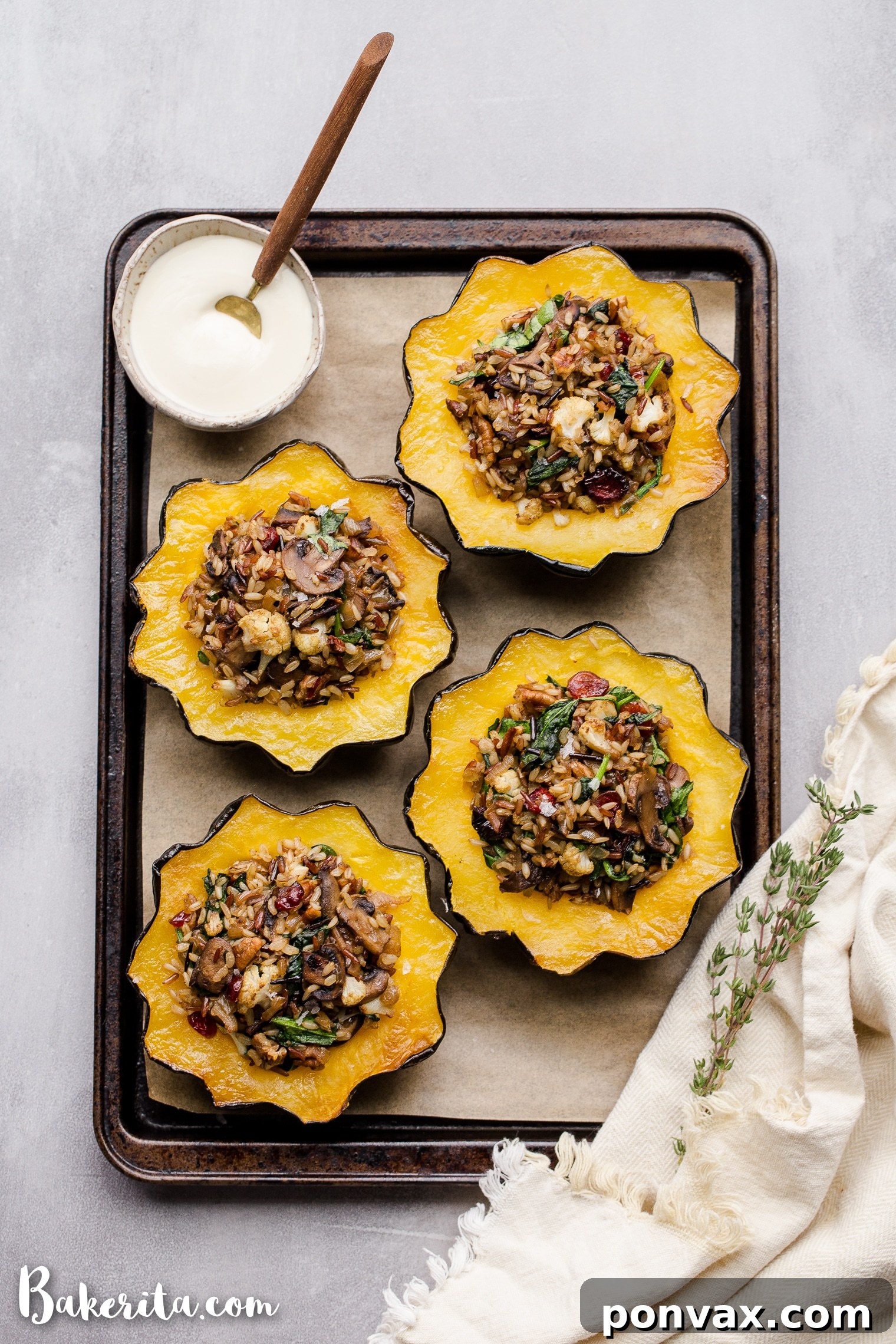 This Mushroom & Wild Rice Stuffed Acorn Squash is filled with caramelized onions, cauliflower florets, spinach, dried cranberries, and pecans. It's served with a drizzle of lemon tahini sauce. This comforting and colorful dish has a variety of texture, tons of flavor, and makes the perfect hearty dinner or side dish.