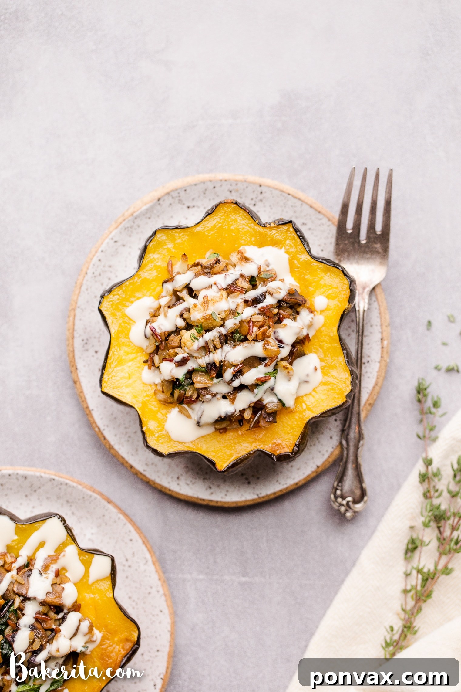 This Mushroom & Wild Rice Stuffed Acorn Squash is filled with caramelized onions, cauliflower florets, spinach, dried cranberries, and pecans. It's served with a drizzle of lemon tahini sauce. This comforting and colorful dish has a variety of texture, tons of flavor, and makes the perfect hearty dinner or side dish.