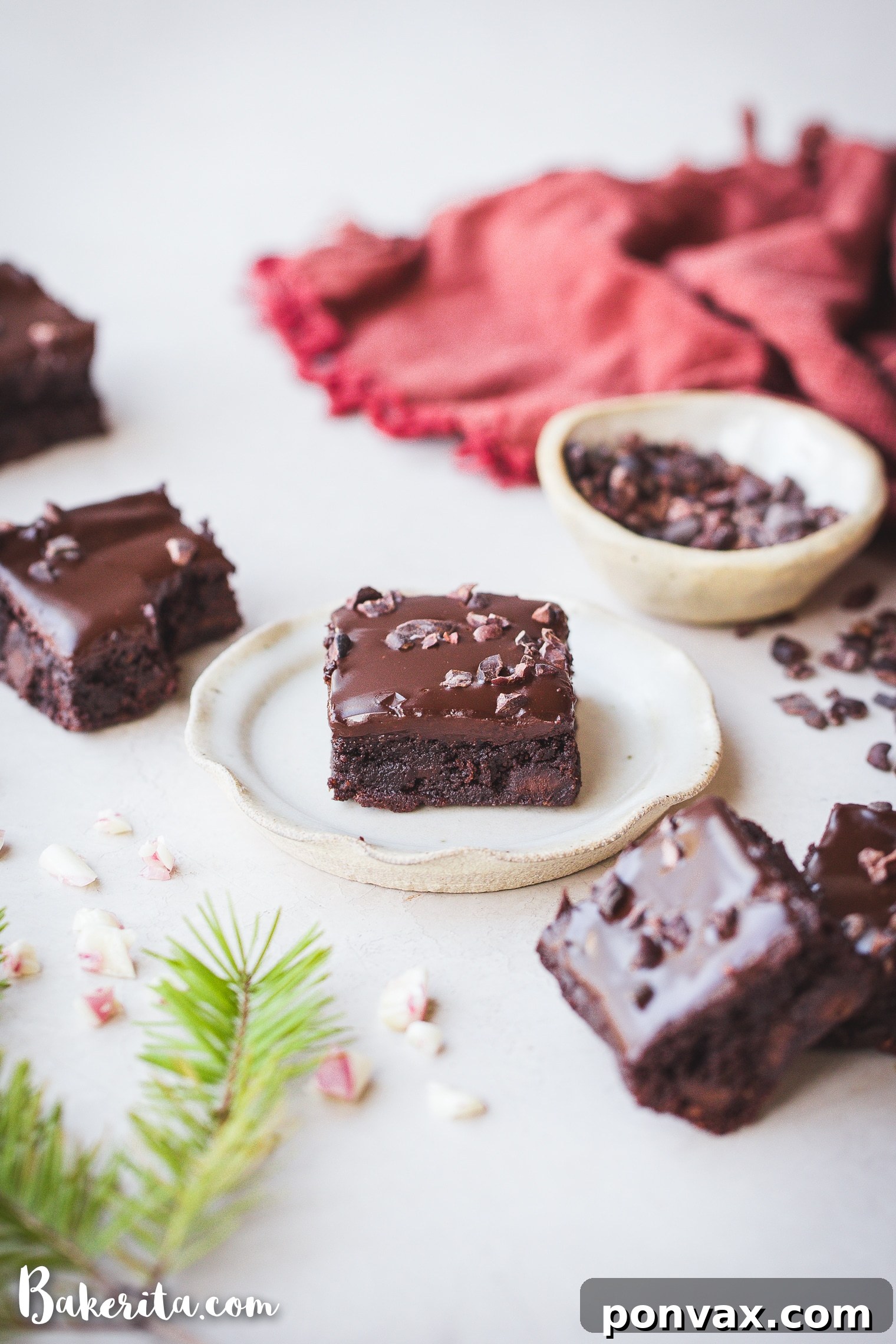 A plate of gluten-free peppermint brownies, showcasing their fudgy texture and festive topping.