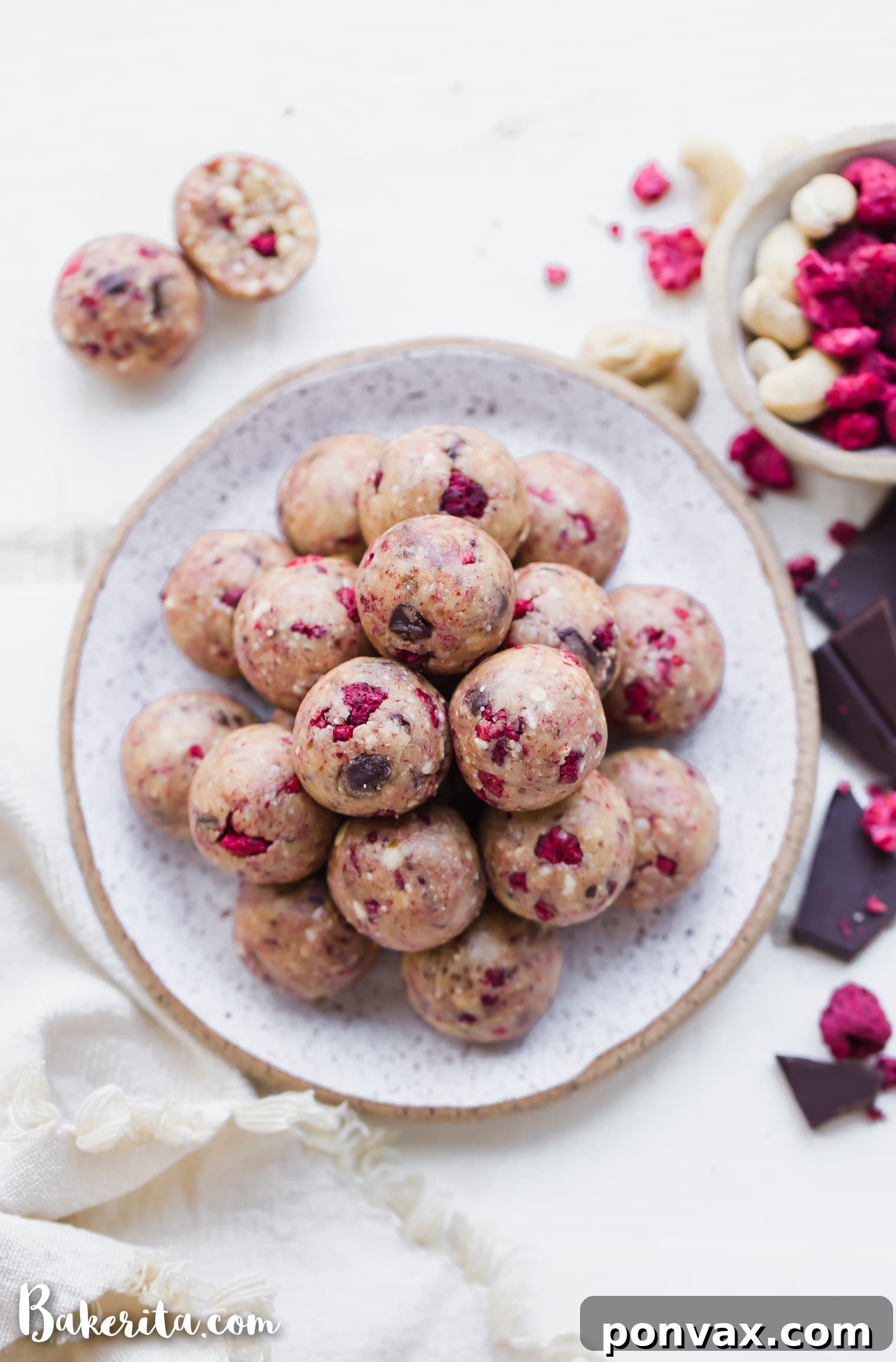 Raspberry Dark Chocolate Power Bites Gluten Free Paleo Vegan 7 Overhead view of homemade Raspberry Dark Chocolate Energy Bites on a rustic wooden surface, ready to be enjoyed.