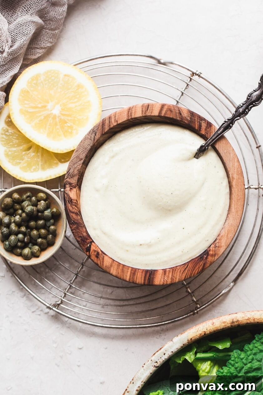 Vegan Caesar Dressing drizzled over a fresh salad, highlighting its creamy texture.