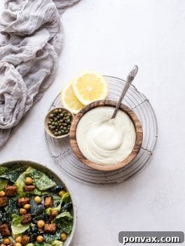 Creamy Vegan Caesar Dressing in a small serving bowl with fresh greens.