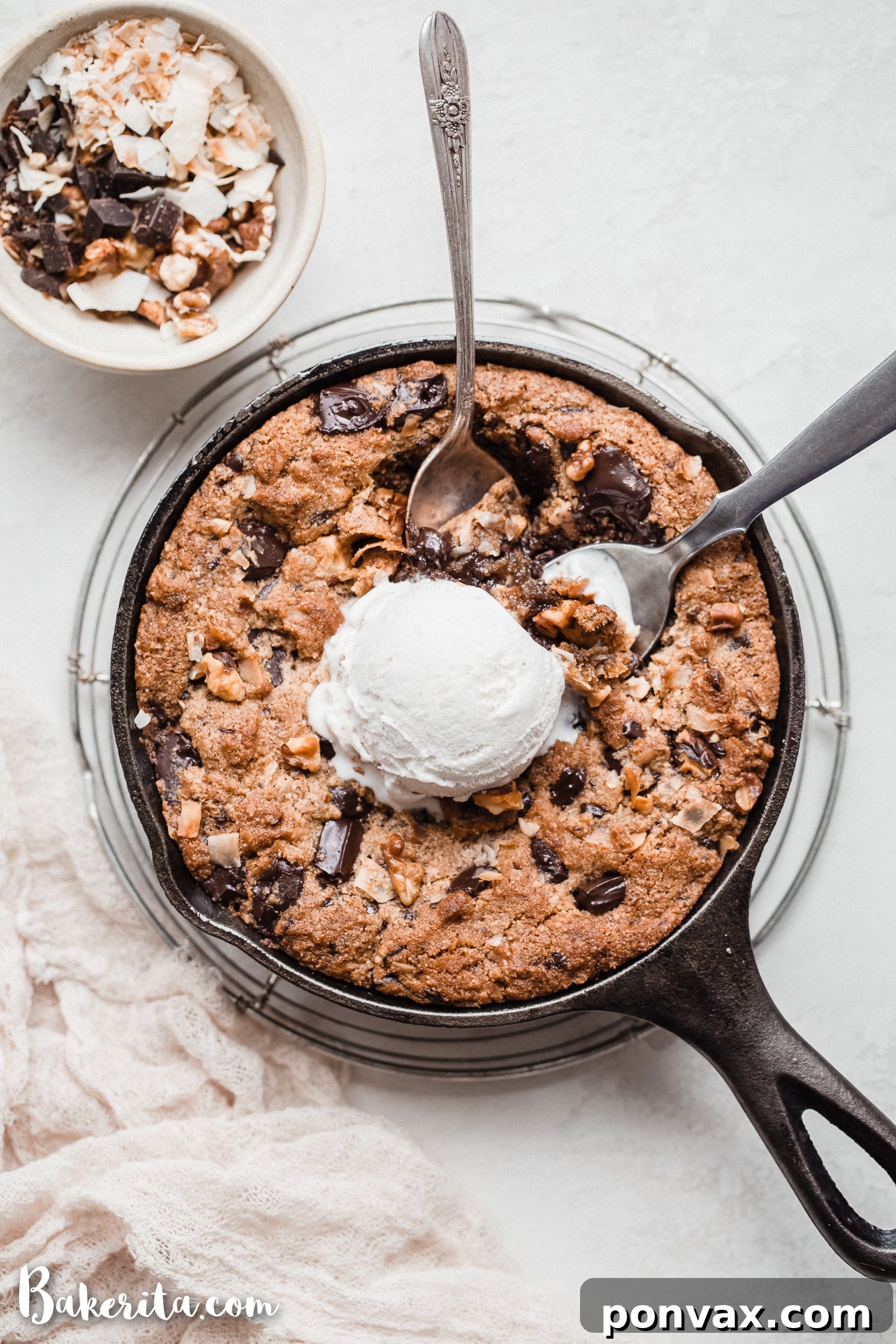Irresistible Gluten-Free Skillet Chocolate Chip Cookie 2 A large, gooey Magic Chocolate Chip Skillet Cookie topped with ice cream, featuring chocolate, walnuts, and coconut. This gluten-free and vegan dessert is baked in a cast iron skillet.