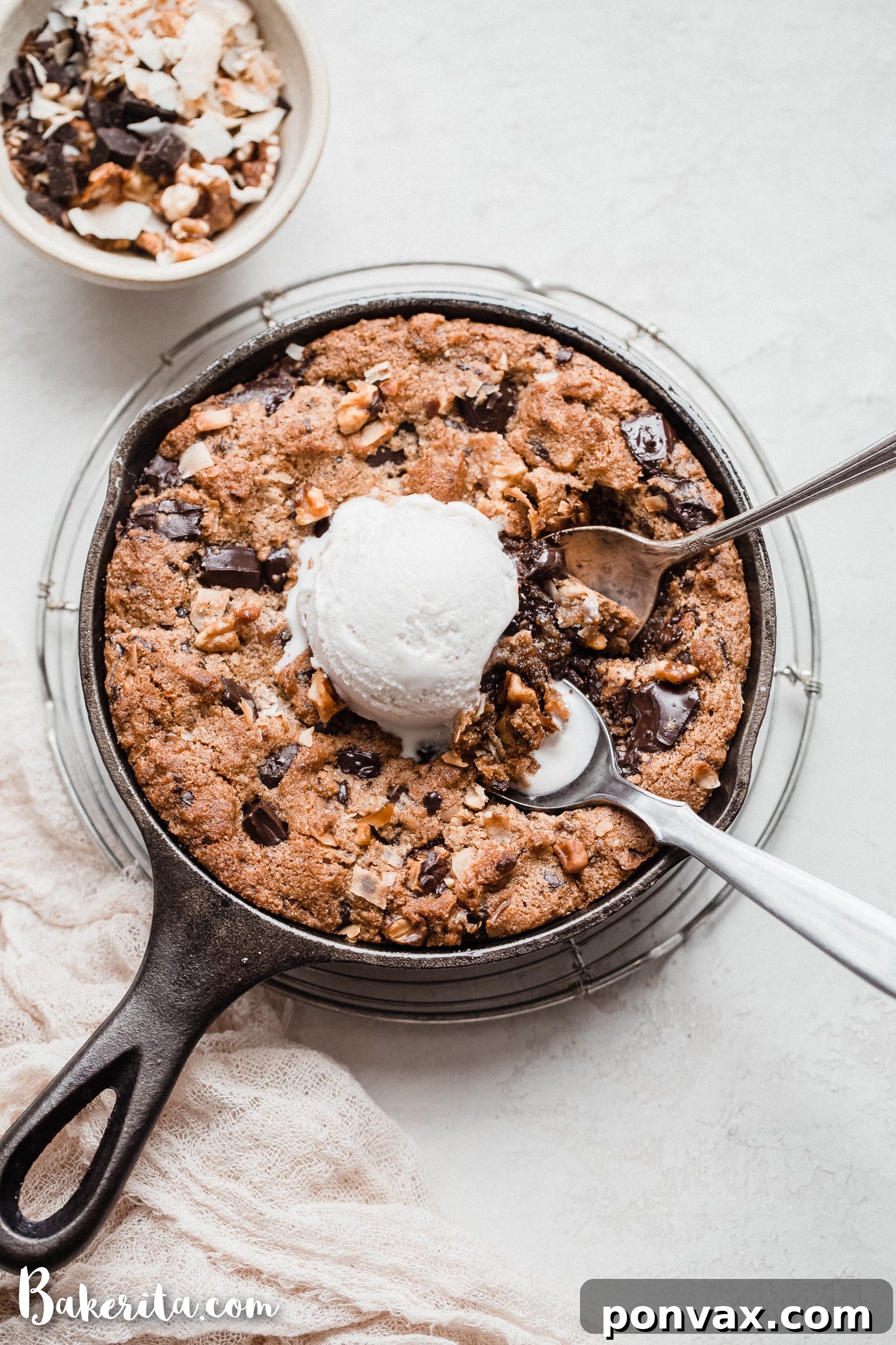 Irresistible Gluten-Free Skillet Chocolate Chip Cookie 5 A baked Magic Chocolate Chip Skillet Cookie, fresh out of the oven, ready to be served. The golden-brown edges and molten chocolate are visible. This is a gluten-free, paleo, and vegan dessert.