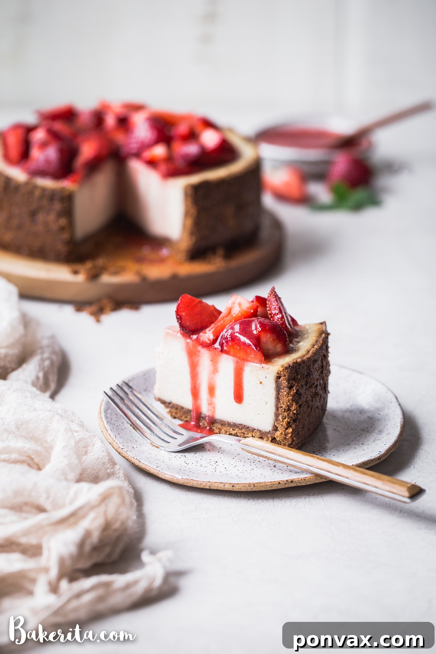Decadent Baked Vegan Cheesecake Gluten Free 6 A beautifully sliced piece of Baked Vegan Cheesecake, adorned with fresh, macerated strawberries, inviting you to take a bite.