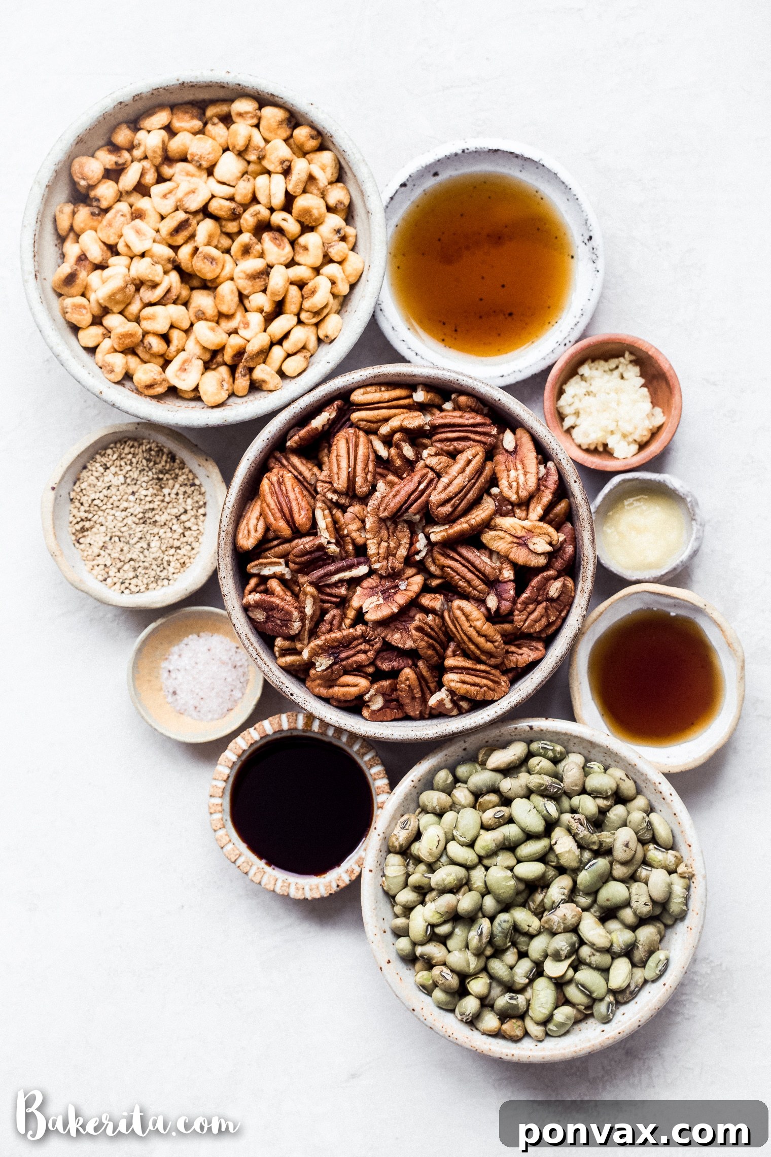 A bowl of Sesame Tamari Pecan Snack Mix resting on a patterned cloth, ready to be enjoyed as a wholesome and flavorful snack.