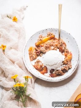 This Gluten-Free & Vegan Peach Crisp recipe is a summer staple! Scented with cinnamon and baked until bubbly, the fresh peaches are perfectly complemented by the pecan crisp topping. Top with a scoop of ice cream for the perfect dessert!