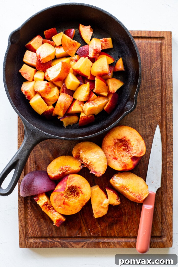 Sliced peaches in a bowl, tossed with spices.