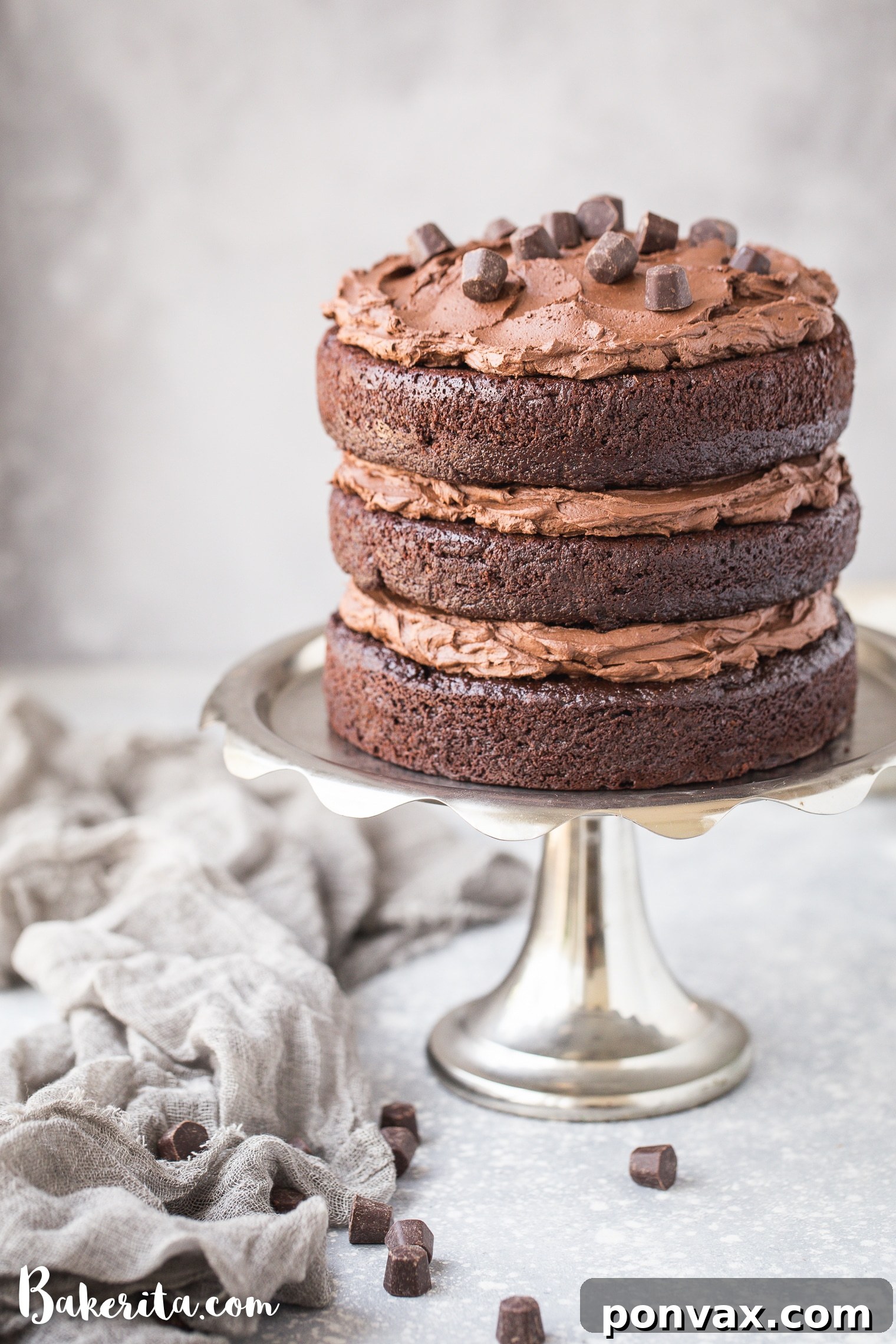 Close-up of a luscious paleo chocolate cake slice topped with smooth vegan chocolate ganache frosting, showcasing its rich texture and depth.