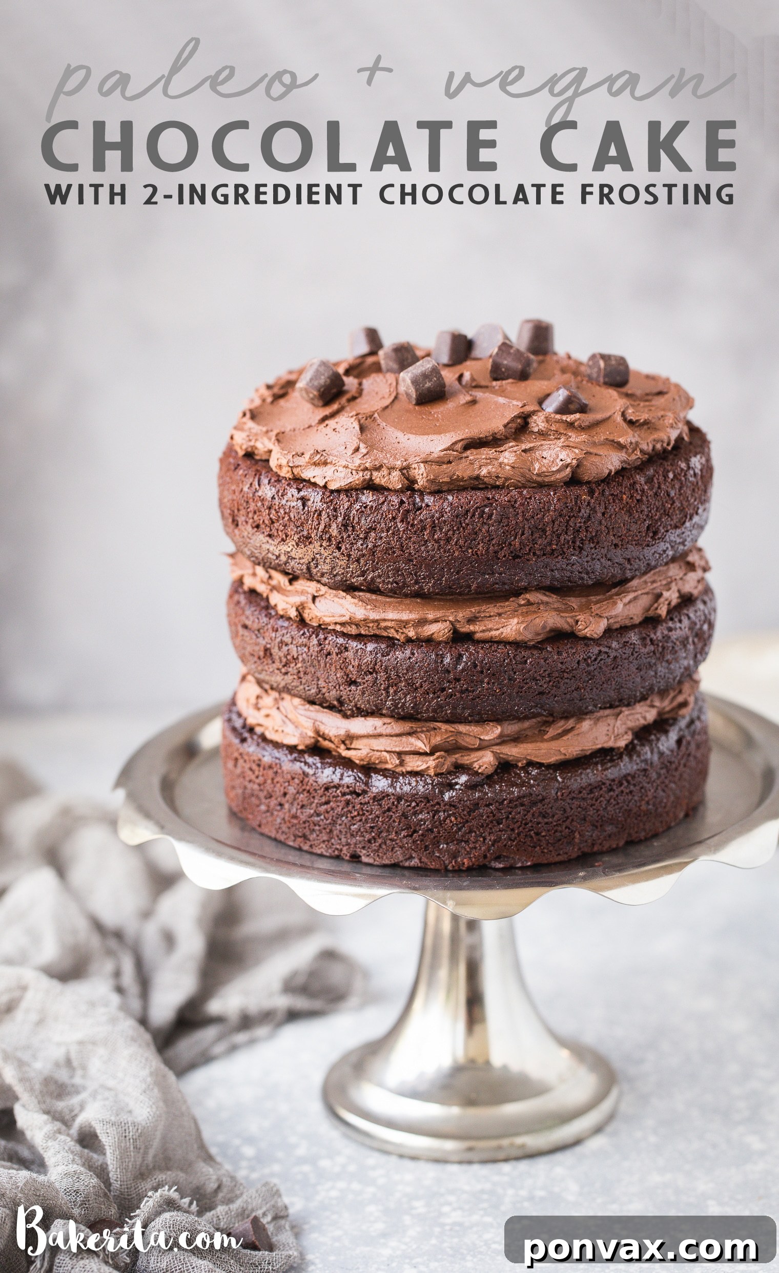 Full view of a multi-layered paleo chocolate cake with vegan ganache, adorned with Hu Kitchen chocolate gems.